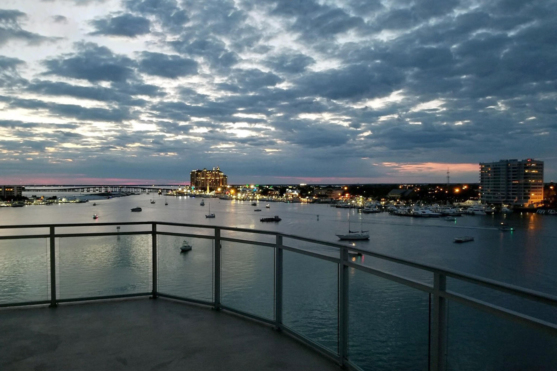 Spectacular views from every room in this 4BR/3.5BA, 3,255SF Penthouse. This penthouse features 1,191SF wrap around balcony with amazing views of the Gulf, Pass, Harbor, & Bay. Other features include 12FT ceiling's, oversized custom doors, & enhanced windows for perfect views. Entering the condo, you are greeted with a $75,000 smart home system, porcelain tile floors, granite countertops, custom wood cabinets & oversized crown molding. This condo also features two master suites, bunk room, 2 private garages, a 50x22 boat slip, and the largest storage unit in the complex. Harbor Lights features gate access, pool, hot tub, gym, dog park, harbor, & deeded beach access. This is the perfect penthouse even though the building was built in 2007, this condo was a shell until 2014. Call me!!