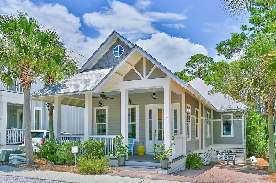 This charming Seacrest bungalow features an open floor plan offset by cozy, rustic touches, such as whitewashed shiplap and sliding barn doors. A vaulted wood-trimmed ceiling and nearly all-white decor in the great room are grounded by rustic dark wooden floors, creating a spacious and serene area for cooking, eating and lounging. When it's time for dinner, the banquette dining table can seat 8 with 3 additional bar stools at the white granite kitchen island. A downstairs media room is another ideal gathering spot with a large sectional sofa and 50'' flat screen mounted inside the built-in bookshelves. Sunnyside Up comfortably accommodates 10 people with two king masters and a twin bedroom upstairs, and a custom-built bunk room downstairs with four twin beds.