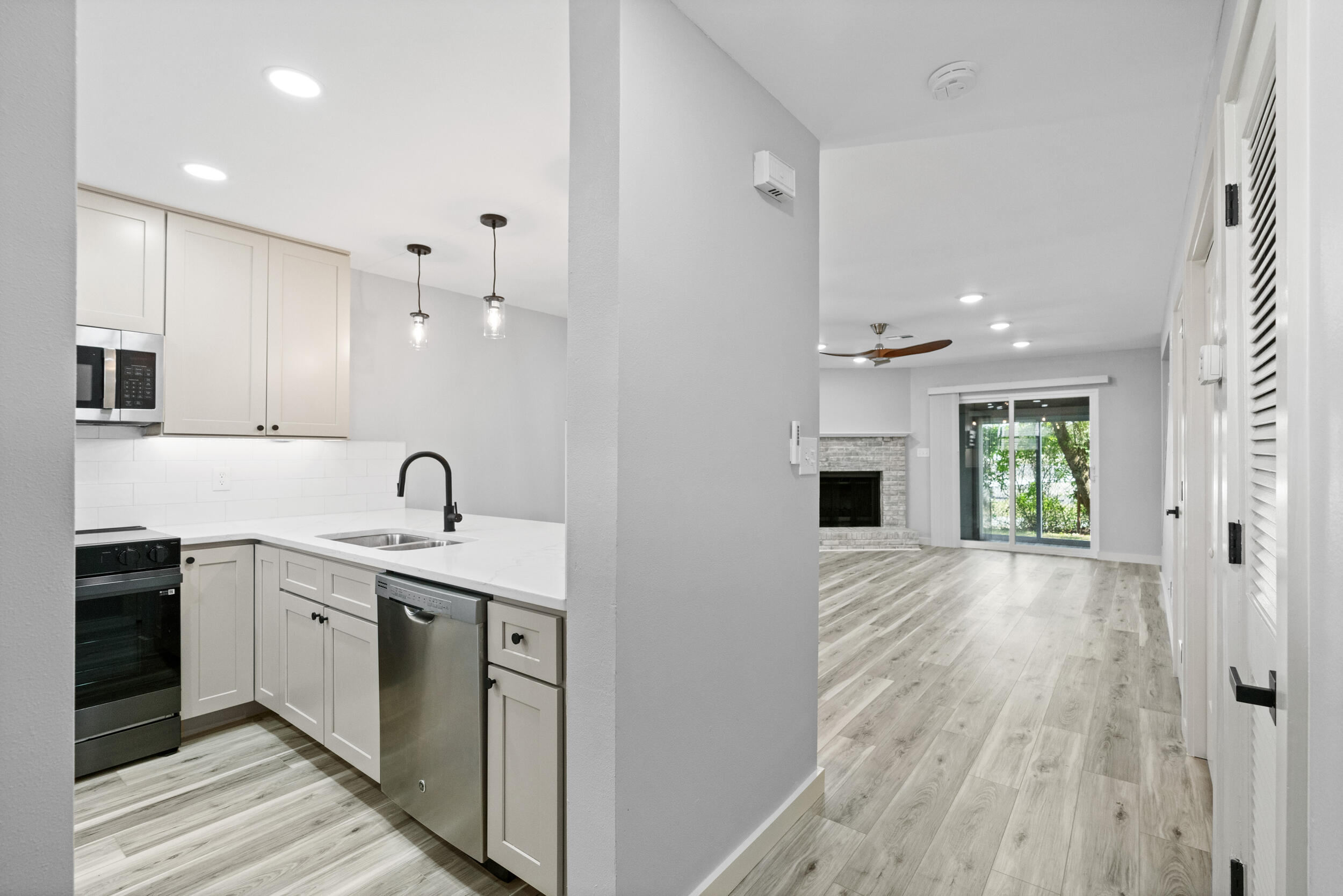 Beautifully renovated 2BR/2.5BA townhome with over $90K in upgrades--nearly every feature is new, including paint, trim, flooring, windows, lighting, fans, all doors, bathrooms, fixtures, and Quartz counters throughout. The kitchen features soft-close cabinets, Quartz countertops, under-cabinet lighting, new stove, and sink. Enjoy the cozy brick fireplace and relax on the enclosed patio and deck. Roof replaced in 2022, HVAC in 2021. Steps to the community pool and less than a mile to the Gulf. Ideal as a primary home, vacation getaway, or rental--style and comfort await.