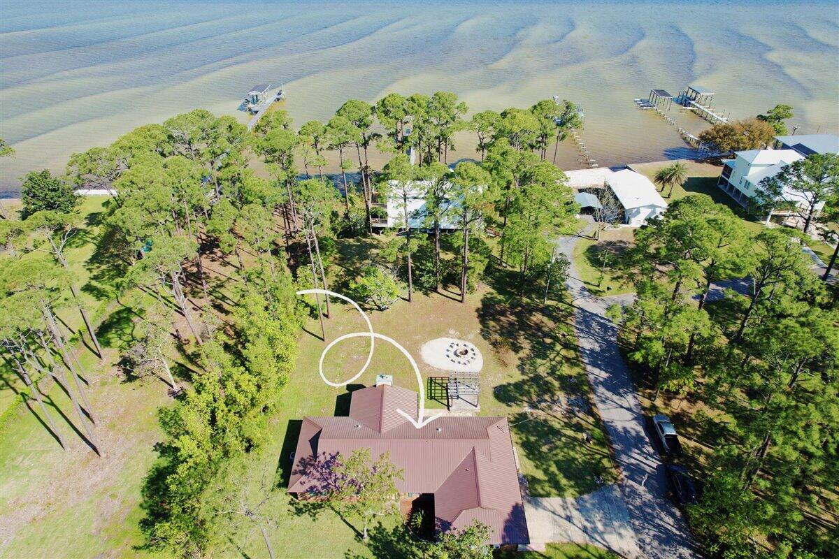 Located in the area of Innerarity point on a 1/2 acre and no HOA. This completely remodeled brick four bedroom, three bath home is a dream come true for anyone looking for a perfect blend of luxury, comfort, and breathtaking views. Nestled just outside Perdido Key, this property boasts spectacular water views of Perdido bay, giving you a front-row seat to nature's beauty. As you step inside this magnificent home, you'll be captivated by the spacious and open living areas, which are perfect for entertaining guests or relaxing by the fire. Did I mention that there are two living rooms?The kitchen features custom cabinetry, with top-of-the-line appliances, and ample counter space.The bedrooms are generously sized, offering plenty of room for everyone. This home features two master suites each with their own bathroom which is great for a little added privacy. There is plenty of space in the oversized two car garage and a laundry/mudroom.
And, for those who love boating, this property comes complete with a boat launch just a couple houses down, allowing you to easily access the bay and explore the surrounding areas. With a park down the street and only minutes away from the beach, you'll have endless opportunities to enjoy the great outdoors.
This property truly has it all. From its prime location to its stunning views and luxurious amenities, this house is the perfect place to call home. Don't miss out on the chance to make this dream a reality.