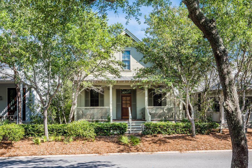 Slip away to your coastal retreat in this 3 bedroom, 3 and -1/2 bath beach cottage found in the very front of Phase I of WaterColor! Watch your stress melt away as you enjoy your morning cup of coffee the expansive covered front porch and relish in the scenic views of the WaterColor Community. As you enter the home, you are greeted with wood floors, soaring ceilings and vast windows featuring transom lighting that can be found throughout the first floor of the home, allowing in tons of natural light. The expansive and timeless U-shaped kitchen features white cabinets and counter tops, offering a light, coastal feel with GE Profile appliances. The spacious downstairs master bedroom offers double doors to the screened in back porch, separate closets, an attached master bath with dual vanities,