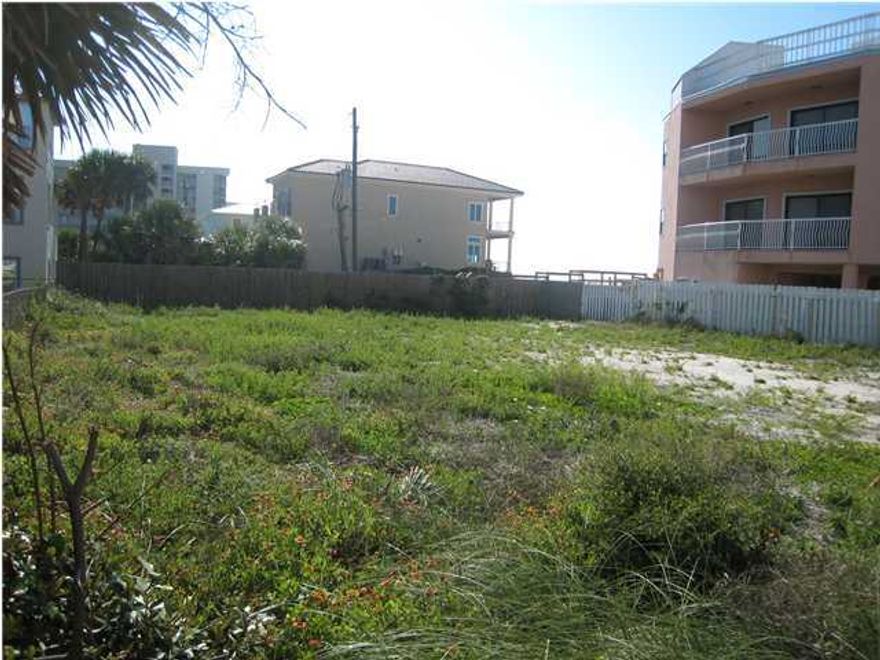 Private, off the beaten track subdivision(with no homeowner's dues) right in the middle of everything. The back yard is fenced with an entrance right on to the deeded beach boardwalk access that is literally a 'few' steps to the beach. Silver Sands outlet mall is only 2 blocks away yet this home site is right there only a stone's throw from the Gulf. Can build over 3,000 sf per floor up to 50 ft (3 stories) on this building pad. Gulf views from this 1st tier lot! Great location!