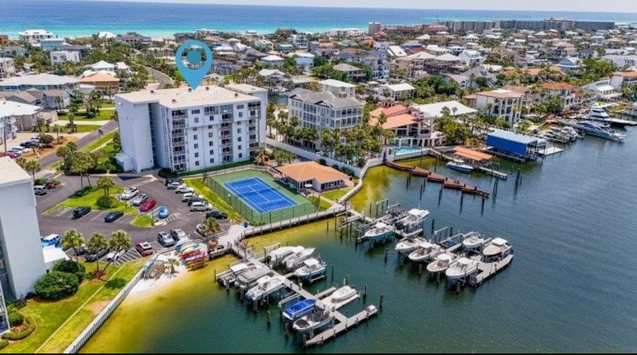 Welcome to a Boaters Paradise!! This Dolphin Point 2-bedroom 2 bath unit with a bunk room/office has been COMPLETELY and professionally renovated with so many details that set it apart from the rest. Once you enter the unit, you'll walk into a Gorgeous Kitchen with all top-of the line appliances, new cabinets, Quartz counters tops, a stylish backsplash and oversized island with plenty of storage. Main living areas have commercial waterproof flooring (LPV) throughout unit. Both bathrooms have been completely redone. Master bathroom has a free-standing tub, double vanity and blue tooth speakers throughout both bathrooms. The second bedroom has bunk beds to offer plenty of space for your guests. Other new appliances include stackable washer and dryer, water heater, HVAC system, hurricane window and sliding doors leading out to the balcony. Wiring was replaced with copper throughout unit. Dolphin Point is one of Destin's best kept secrets as a boater's paradise and is situated on Holiday Isle only sets away from the beautiful white sand beaches and a short taxi ride away to all Destin has to offer. Amenities include private gated beach access, large, heated pool, private club house, pickle ball & tennis courts, paddle boards/kayak launch, BBQ grills, golfcart parking and so much more.
This condo is not just a home, it's a lifestyle! Don't miss the opportunity to own this piece of paradise. Call today to schedule a showing and experience all this condo has to offer.