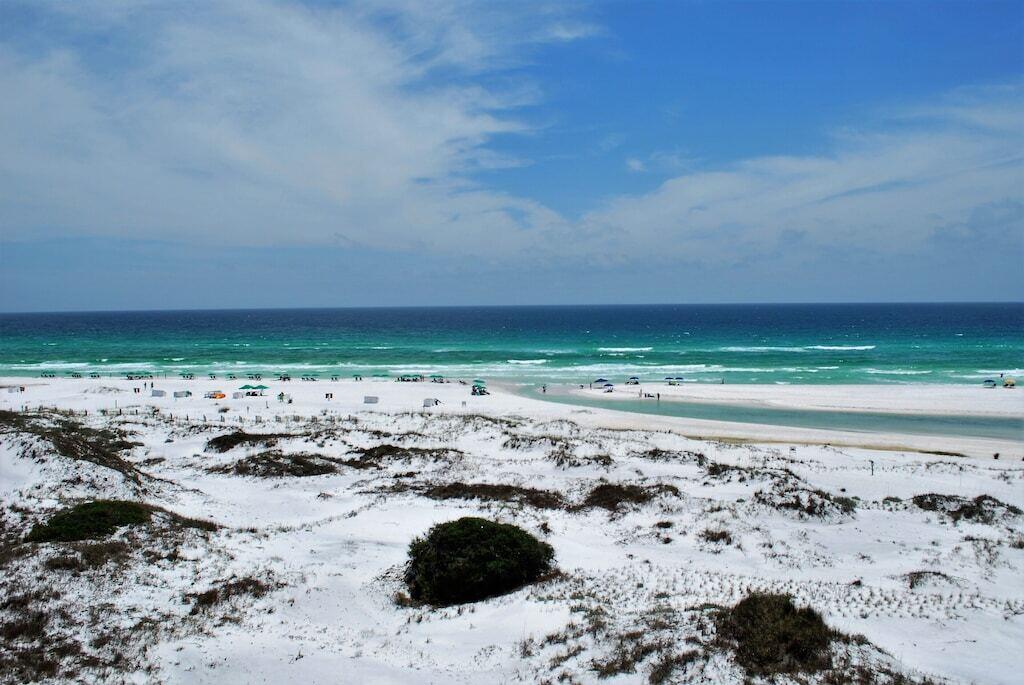 Enjoy stunning views of the Gulf of Mexico and Big Redfish Lake from this 2-story, 4BR, 4.5BA property at Sanctuary By The Sea. An ideal vacation rental, or second home at the beach, this stunning condo features two waterfront master suites, a chef's kitchen and ample living space for entertaining. Ten foot ceilings and sliding glass doors provide water views, even when relaxing by the fire. This gated community is a true sanctuary with 650 feet of sandy white beachfront and miles of beach to run, walk and explore. Amenities include 24-hour security, fitness room, virtual golf, theater room, a large zero entry pool, hot tub fire pit and grills located on the east side of the property, and two additional pools, another hot tub and fire place on the west side. Just a quick bike ride to MORE