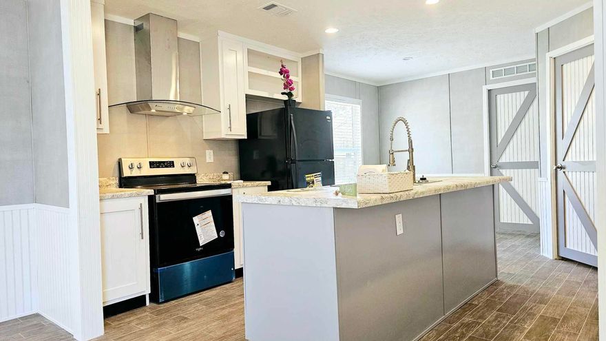Brand-new, never lived in, move-in ready 2022 Hamilton Home on a large corner lot with lake views from the front porch and both guest bedrooms! Enjoy peaceful lakefront living with quick access to a nearby boat launch. No HOA! This home features a metal roof, premium vinyl siding, Low-E vinyl windows, 8' flat ceilings, and energy-efficient in-floor HVAC system. The open floor plan centers around a modern kitchen with stainless steel vented hood, large pantry, and Whirlpool appliances. The private owner's suite offers a spa-like bath with double vanity, soaking tub, shower, and walk-in closet. Includes 50-gallon water heater, LED lighting, textured ceilings, and crown molding. Located just 3.3 miles to Downtown DeFuniak and 34.5 miles to the white sands of Seaside. 10-year builder warranty