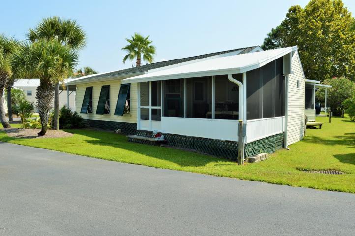 GREAT OPPORTUNITY in Emerald Pointe Resort! This could be your new home or short term rental investment property!! FULLY FURNISHED. Largest Lot in the community. Located near back swimming pool. 3 Bedrooms, 2 full baths, custom LED lighting in carport with covered parking for 4 cars, and screened in porch. Hardwood floors, semi custom cabinets, stainless appliances, and great living space both inside and outside! Emerald Pointe Resort is a gated community with 2 pools, hot tubs, playgrounds,and near all Panama City Beach has to offer. The HOA fee covers ALL but your power bill making life at the beach easy! GOLF CART INCLUDED!! This will not last long!