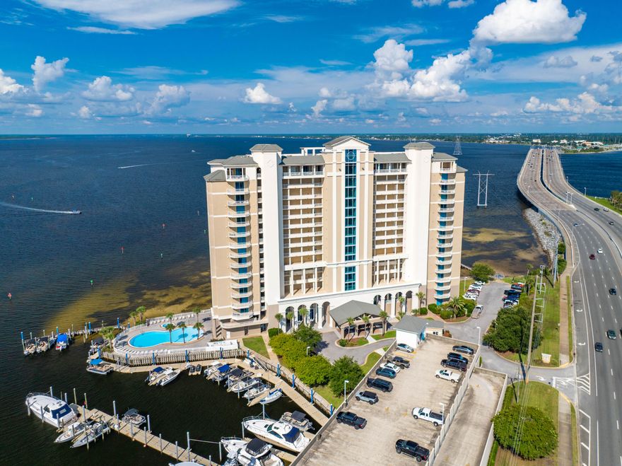 Experience elevated coastal living at Marina Landing Unit 404, a beautifully appointed 2-bedroom, 2-bath bayfront retreat with sweeping views of St. Andrews Bay, offered fully furnished with tasteful updates and thoughtful design throughout. This fourth-floor residence is ideally positioned just off the elevator and includes a private storage closet with rare electrical access. Enter an open-concept living area where floor-to-ceiling glass showcases sweeping water views. The renovated kitchen features stone countertops, stainless steel appliances, abundant cabinetry, and a pantry housing the in-unit laundry. Elegant lighting and updated fixtures elevate every corner of the interior, complemented by new LVP flooring and freshly painted walls. The living and dining areas center around a cozy fireplace and flow seamlessly onto a massive 500 sq ft covered balcony  your private outdoor sanctuary, complete with a built-in grill and plenty of space for lounging and entertaining. From here, enjoy unobstructed views, soft bay breezes, and frequent dolphin sightings that make every day feel like a postcard. 

The primary suite offers direct balcony access, room for a king-sized bed, and breathtaking water views. Its luxury ensuite bath includes a double vanity, a deep soaker tub, a separate glass-enclosed shower, and a generous walk-in closet. The spacious second bedroom also enjoys bay views, private balcony access, an ensuite bath with updated cabinetry, and its own walk-in closet. 

Community amenities include: 
Resort-style bayfront pool 
Well-equipped fitness center 
Resident meeting room 
Walk-out dock with kayak and paddleboard access 
Natural walking path along the bayfront 
Adjacent marina offering slips for rent 
Covered, assigned parking (Space #68) 

This residence combines refined finishes, unmatched views, and tranquil surroundings in a well-maintained, upscale community just minutes from beaches, dining, and local attractions. 

Offered furnished with an exclusions list and updates list in the Documents section.