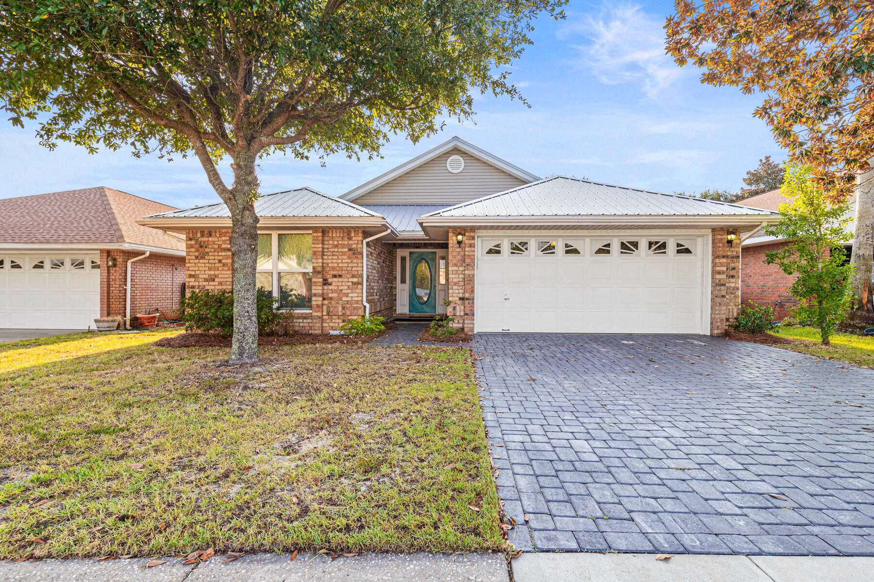 Welcome to Crystal Beach: Your Coastal Paradise Awaits!Discover the perfect blend of coastal charm and modern convenience in this stunning 1,919-square-foot brick home. Located in desirable Crystal Beach, this property is a short stroll from the sugar-white sands and emerald waters of the Gulf of America, with convenient NEW public beach access and facilities. This home has been thoughtfully updated to provide a comfortable and stylish living experience. An inviting open-concept floor plan greets you with beautiful Calacatta Marble tile flooring that flows from the front entrance through the main living areas and bathrooms. In the dining and family rooms, you'll find elegant oak wood flooring, creating a warm and cohesive feel. A cozy gas fireplace with a marble tile hearth and stone surround provides the perfect ambiance for cooler evenings. The kitchen has been recently renovated and features classic shaker beadboard cabinets, granite countertops, and a full tiled backsplash. It is fully equipped with stainless steel appliances, including a gas range. A Relaxing Retreat: The spacious primary suite offers a private sanctuary with plush carpeting and a large walk-in closet. The ensuite bathroom is a spa-like escape, boasting marble tile flooring, a dual vanity with shaker beadboard cabinets, a relaxing garden tub with a marble tile surround, and a separate tiled shower. The split floor plan ensures privacy and comfort for guests and family. Two additional generously sized, carpeted bedrooms share a guest bathroom featuring marble tile flooring and a glass-enclosed tub/shower combo. Outdoor Oasis & Community Perks: Step outside to your private backyard oasis, perfect for relaxing or entertaining. The stylish paver driveway extends to the rear patio, where you'll find a welcoming firepit area. The property, situated on an inner-circle lot, is secured with a backyard fence and a new irrigation system. A two-car garage with an upgraded door w/windows and opener provides ample storage. This property is part of a low-fee HOA community with a pool. It offers one of the lowest annual HOA fees at just $420 and has no rental restrictions, making it an excellent option for both a primary residence or a smart investment property. With its blend of modern amenities and coastal charm, this home is a rare find. It offers the perfect opportunity to embrace the vibrant beach lifestyle you've always dreamed of. Schedule your private showing today and start living the beach life!