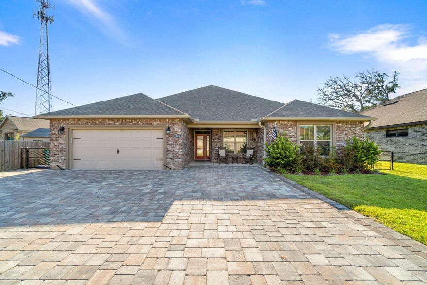 Custom built home by multiple Parade of Homes winner Watree Homes. This home has 4 bedrooms, 2.5 baths and more than enough space to entertain. Too many upgrades to list, starting with the over 100 foot custom paver driveway. Home is fully tiled with woodgrain styled ceramic tile. The walls are 9 foot with a double tray in the living room and single tray in the master bedroom, both with recessed lighting. The kitchen has cultured marble countertops, a glass backsplash, stainless steel farmhouse sink, all soft-close drawers/cabinets and more than enough storage. All corners are smooth, rounded bullnose corners. Oversized soaker tub and separate glass enclosed shower in Master Bathroom. Open and airy split floorplan. In addition to the covered back porch there is an extended 35x10