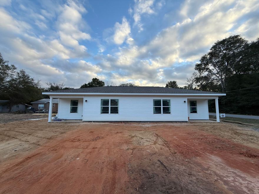 $10,000 Builder Credit or Rate Buy Down! Introducing a brand new 2-unit duplex located within the city limits of DeFuniak Springs. Each unit spans 750 square feet and features 2 bedrooms, 1 bathroom, and a convenient laundry/utility room with washer/ dryer hookups. Key highlights include soundproof insulation between the units for enhanced privacy, durable LVP flooring throughout, elegant granite countertops in the kitchen, and stylish shaker cabinets. Enjoy the amenities of a covered front porch and a concrete back porch, complete with a separating privacy fence to ensure a tranquil outdoor space. Live in one unit and rent the other to offset your monthly mortgage!