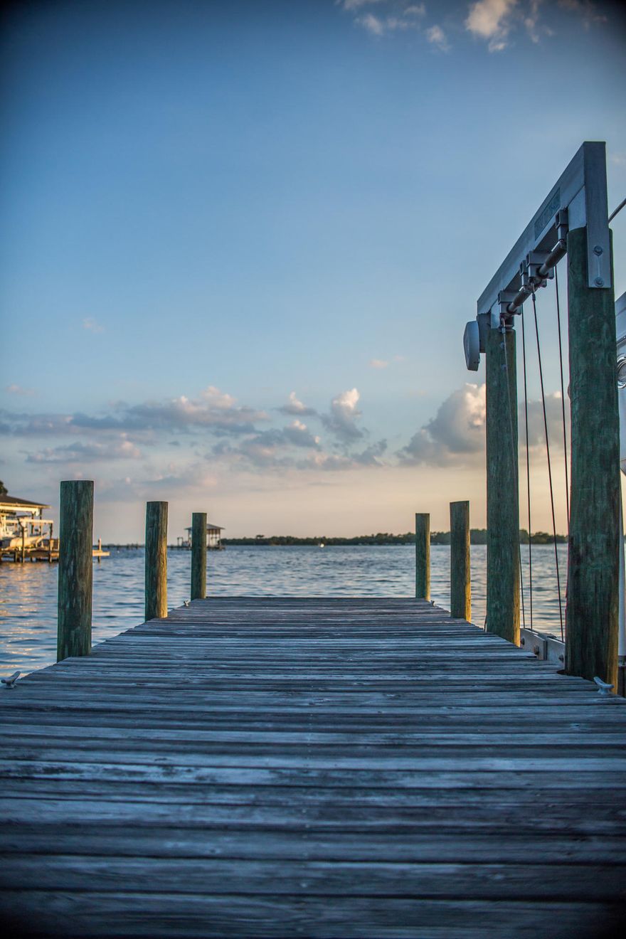 Boasting over 220 feet of water frontage,this stunning home is a custom Gary Miller house built in the middle of two large waterfront lots.The views are incredible from this property! The home is accessed by a long circular driveway that divides gorgeously manicured and landscaped gardens.The double leaded glass front door opens to the spacious living room and a breathtaking view of the Choctawhatchee Bay beyond. With soaring twelve foot ceilings in most rooms, accented by extra wide crown moulding, the entire home is light, open and airy. A state of the art kitchen with stainless steel appliances provides plenty of preparation and serving areas on the huge breakfast bar.With a large vented walk-in pantry and lots of storage areas, this home can accomodate large parties, with extra guests able to spill out onto the covered patios through multiple sliding glass doors.This single story floor plan features four bedrooms with two full and one half baths,spacious walk-in closets and an extra deep and wide garage that will be the envy of your neighbors. 
The beautiful backyard mirrors the front with many trees and mature gardens that extend all the way to the water's edge where the covered dock and its three boat lifts can accomodate small, medium and large boats with water depth of approximately 7 feet. The white sand beach near the dock provides a place to tan, frolic in the warm waters of the bay, or relax and watch the sunset.
The photos tell the story- this is a rare opportunity to own a spectacular custom home on a huge and extraordinary waterfront location. This lovely home won't last long!