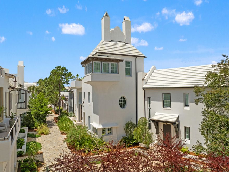 Welcome to 52 Butterwood Alley, an architectural masterpiece designed by renowned architect Gary Justiss, embodying the essence of Bermuda and Guatemalan courtyard living. This iconic 4,975 square foot residence is nestled at the southern end of Lake Maryland, offering breathtaking views of the neighborhood's distinguished architecture, scenic rooftops, and the tranquil backdrop of protected nature preserves.As you approach this stunning 4 bedroom plus bunk home, you are greeted by masterfully crafted woodwork by EF San Juan, featuring wormy oak accents that create a unique and inviting atmosphere. The home's third-story tower room provides an elevated vantage point for entertaining, practicing yoga, or simply enjoying serene evenings by the fireplace. The seamless transition to the outdoor roof terrace invites you to stargaze in the comfort of your own haven.

Access the property via the famed Seagarden walk pedestrian path, where monumental louvered sliding doors lead into the private courtyard. This outdoor oasis features a summer kitchen, pizza oven, dining banquet, and a refreshing swimming pool - perfect for gatherings and relaxation.

Stepping inside, the first level showcases cascading walls of Venetian plaster throughout the kitchen, dining, living areas, and the primary suite. The primary suite is a luxurious retreat, adorned with wormy oak details and a grotto niche bathtub lined with lava tile. Nestled between the courtyard and a separate private courtyard with its own fireplace, this suite allows for an abundance of natural light and gentle breezes when the sliding doors are open.

The gourmet kitchen is a culinary delight, featuring top-of-the-line Subzero appliances and a well-appointed scullery with a secondary refrigerator. Its thoughtful design fosters connectivity with the dining and living rooms, ensuring a welcoming space for guests.

Ascending to the second floor, you'll discover a cozy common area, complete with built-in shelves and a charming nook with wormy oak ceiling ideal for leisurely naps or quiet reading. This level also hosts three guest suites, including a detached casita for special visitors, a bunk room, and a versatile multipurpose room perfect for movie nights or creative endeavors. Each guest room can be accessed through the main home or via an external staircase, providing convenience and privacy.

Finally, guests are invited to the third level, where the home's iconic tower awaits. This unmatched space features Venetian plaster, a two-way fireplace, and vaulted wormy oak ceilings. Slider doors open to the expansive roof terrace, creating the ultimate interactive entertainment venue.

Don't miss the opportunity to own this exquisite property that harmonizes luxury, comfort, and nature in the heart of Alys Beach.  Schedule your private tour today!