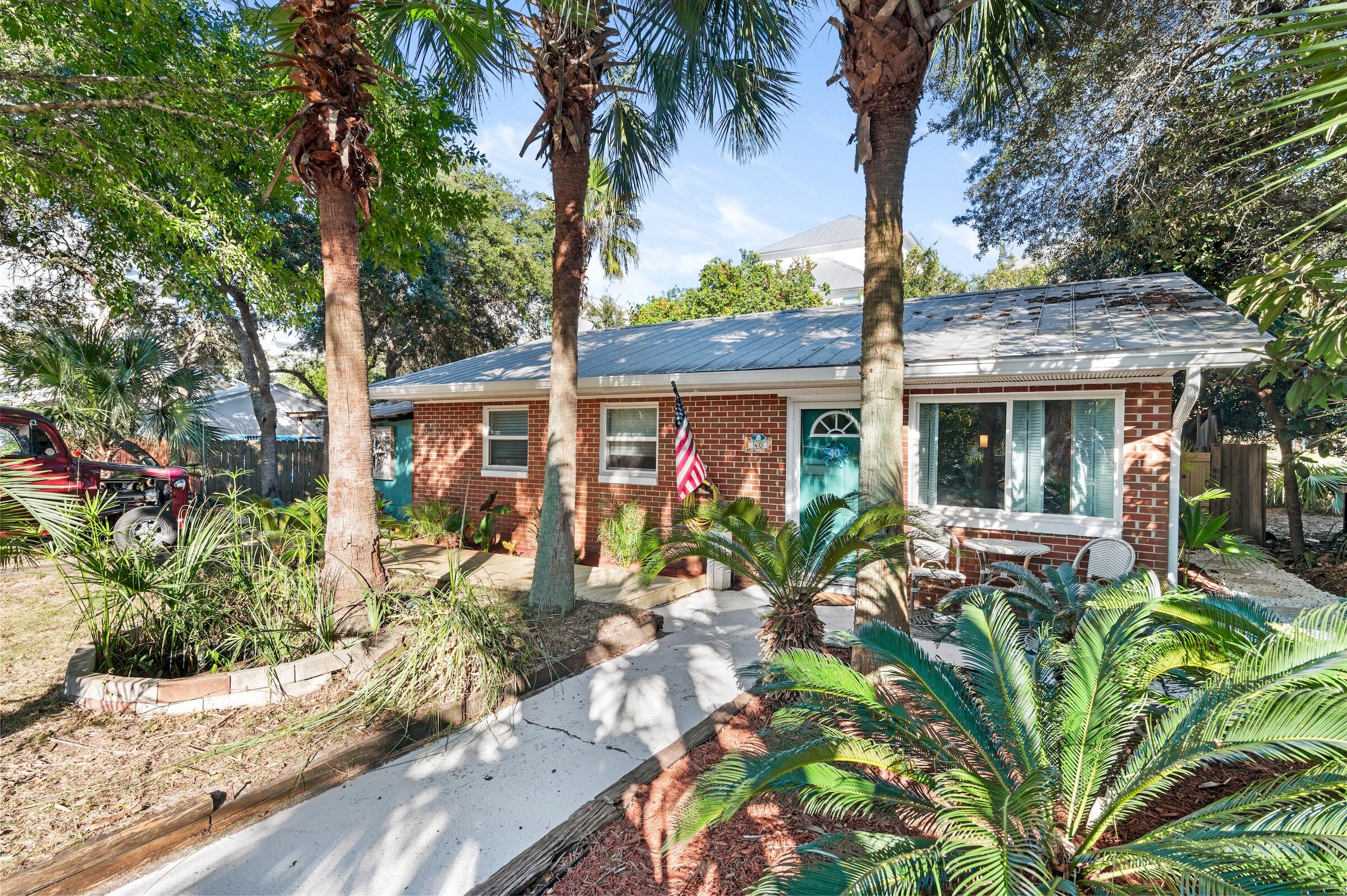 Fantastic one-of-a-kind Florida beach cottage located in the heart of Blue Mountain Beach in desirable Blue Gulf Resort, just a 1/2 mile to the beach & emerald green waters of the Gulf of Mexico! This home is located in the historic community of the ''Brickyard'' and features an extra half lot, which is rare. This ideal property is a one-level home with ample outdoor living & a prime location just a few homes off of 30A. One of the main features is the incredible outdoor space complete with a unique custom areas like a screened-in 'she shed' with metal roof, plentiful sitting areas, outdoor shower & bathroom, incredible Tiki bar, playhouse, music room, multiple sheds & even a jetted tub to unwind in after a day at the beach! Backyard is fenced with 2 side entrances with new wooden gates. The backyard is also fenced for privacy and can be accessed from the kitchen as well. This brick home has withstood the test of time good bones and an updated metal roof, brand new gutters and new wooden walkway at the front. Tropical landscaping surrounds the home lending a nice coastal feel. Interior has been updated with tile floors throughout for easy maintenance for beach living. There living area has nice natural light with the large window at the entrance and there is updated lighting throughout and crown molding. Kitchen has an added island great for casual dining with a unique epoxy countertop reminiscent of the ocean. Kitchen also features stainless steel appliances that convey, a custom metal backsplash, wainscotting and a charming dining nook by the large window. Original ceilings & wood paneling add to the "Old Florida" charm. 

The master bedroom has enough room for a king bed and features an ensuite half bath with partially tiled walls and a pedestal sink. There is a shared full bathroom with tiled shower and custom epoxy vanity and updated lighting. There are two guest bedrooms each with crown molding. Head to the backyard off the kitchen and enjoy plentiful areas to unwind and relax in. Back porch is covered with a metal roof along with the amazing screened-in "she shed," the perfect spot to relax and snuggle up with a good book. The extra half lot allows for fantastic outdoor living and additional parking and entices you to take more time for outside enjoyment and that beach lifestyle everyone desires. The charm of the unique outdoor nooks truly cannot be replicated! This will make a great full time residence or second home as the community is laid back with no HOA fees. There is also great potential as a rental property as similar properties in the area have done as high as $100k in annual income! The vicinity to the beach and exceptional dining & entertainment options nearby makes this a prime investment and one of the best values for 30A overall! 

Blue Gulf Resort is a prime location in Blue Mountain close to many conveniences - bike path, For the Health of It market, Blue Mountian Bakery, Bike Daddy's Bike Shop, McTighes, Mimmo's, Gulf Place, and even Grayton Beach State Park in close vicinity. Access the beach just over 1/2 a mile away. The nearest public access is at the south end of Highway 83 with parking and restrooms but there is also an additional access across the street behind Redfish Circle that this community has an easement to access.

Blue Mountain Beach is the highest elevation of Florida's Gulf Coast lending incredible views and beautiful natural dunes and wild flowers. Enjoy the great outdoors with the surrounding state parks, nature trials and the 22-mile bike & jogging path. Kayak or paddle board on one of the rare coastal dune lakes and experience a unique ecosystem that is only available to approximately 11 locations in the world! You are also close to the picturesque towns of Seaside, WaterColor and Rosemary Beach. Do not miss out on this incredible opportunity to own a historic updated 3-bedroom home in a prime location close the beach!