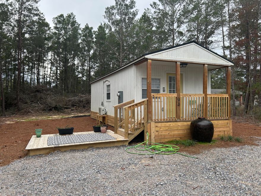 OWNER FINANCING AVAILABLE!  Don't miss out on this cozy, fully furnished tiny home, offering both comfort and style in a compact space. The spacious living area is perfect for relaxing, with enough room for a fold-out sofa bed, making it ideal for guests or extra seating. The modern kitchen is designed with functionality in mind, featuring new cabinets, a full range and oven, a built-in microwave, a stainless steel sink, and a full-size refrigerator. The butcher block counter-tops add a touch of warmth and charm. For year-round comfort, the home comes equipped with an energy-efficient ductless A/C and heating system, ensuring you stay comfortable no matter the season. This tiny home offers everything you need  in a beautifully efficient package. Lets make it yours today!