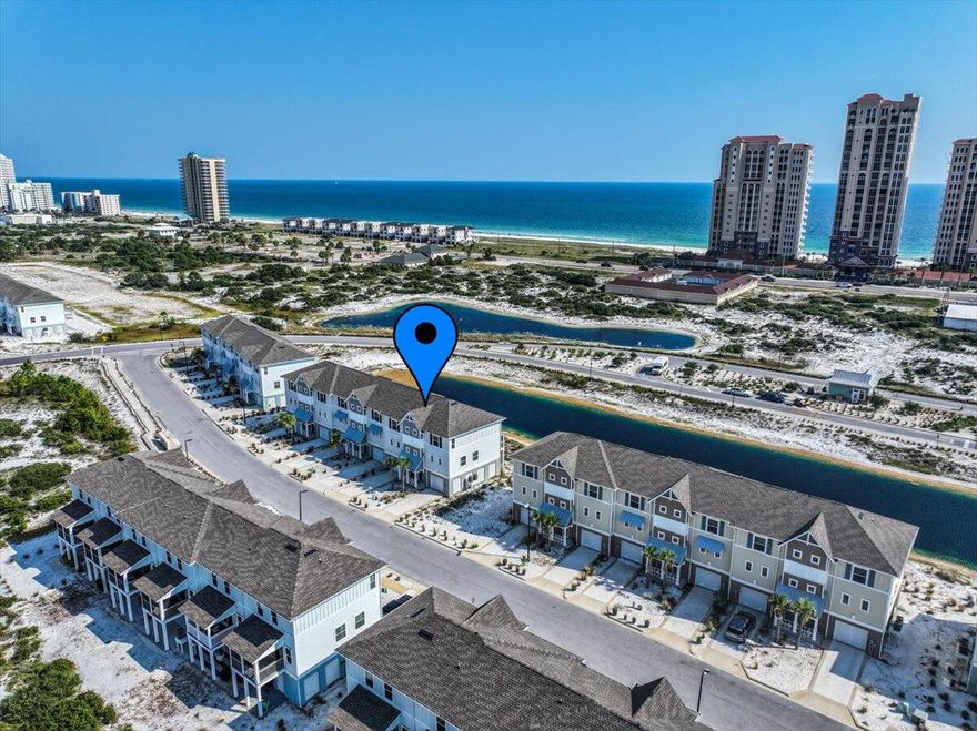 Looking for your escape to Perdido Paradise? This 3 bedroom, 2.5 bath townhome in the Lost Key Golf & Beach Club is waiting for you! Located in the heart of Perdido Key - convenient to shopping, dining, nightlife, and more! Not to mention all of the fantastic amenities that Lost Key has to offer - including the waterfront Lost Key Beach Club to grab a bite to eat and enjoy the private Beach access, an amazing zero-entry Olympic size swimming pool, fitness center, and you can become a member of the Lost Key Golf Club! This townhome offers 3 stories of space. The first floor is a 2 car tandem garage to stow all of your water toys and beach gear. Up the stairs to the second floor, you'll find your main living area. Complete with a full kitchen with shaker style cabinets, gorgeous quartz coun tertops, stainless steel appliances, and a breakfast bar that looks out into the dining area and living room. A slider door leads you to the screened in patio with fantastic water views and the perfect spot to catch the Blue Angels fly by. The 3rd floor hosts the laundry room, full guest bathroom, and all of the bedrooms - including the primary suite with ensuite featuring a double vanity and Tiled walk-in shower. With excellent rental history, and loads of activities to do in the area, this is a can't beat property! Schedule your showing today!
