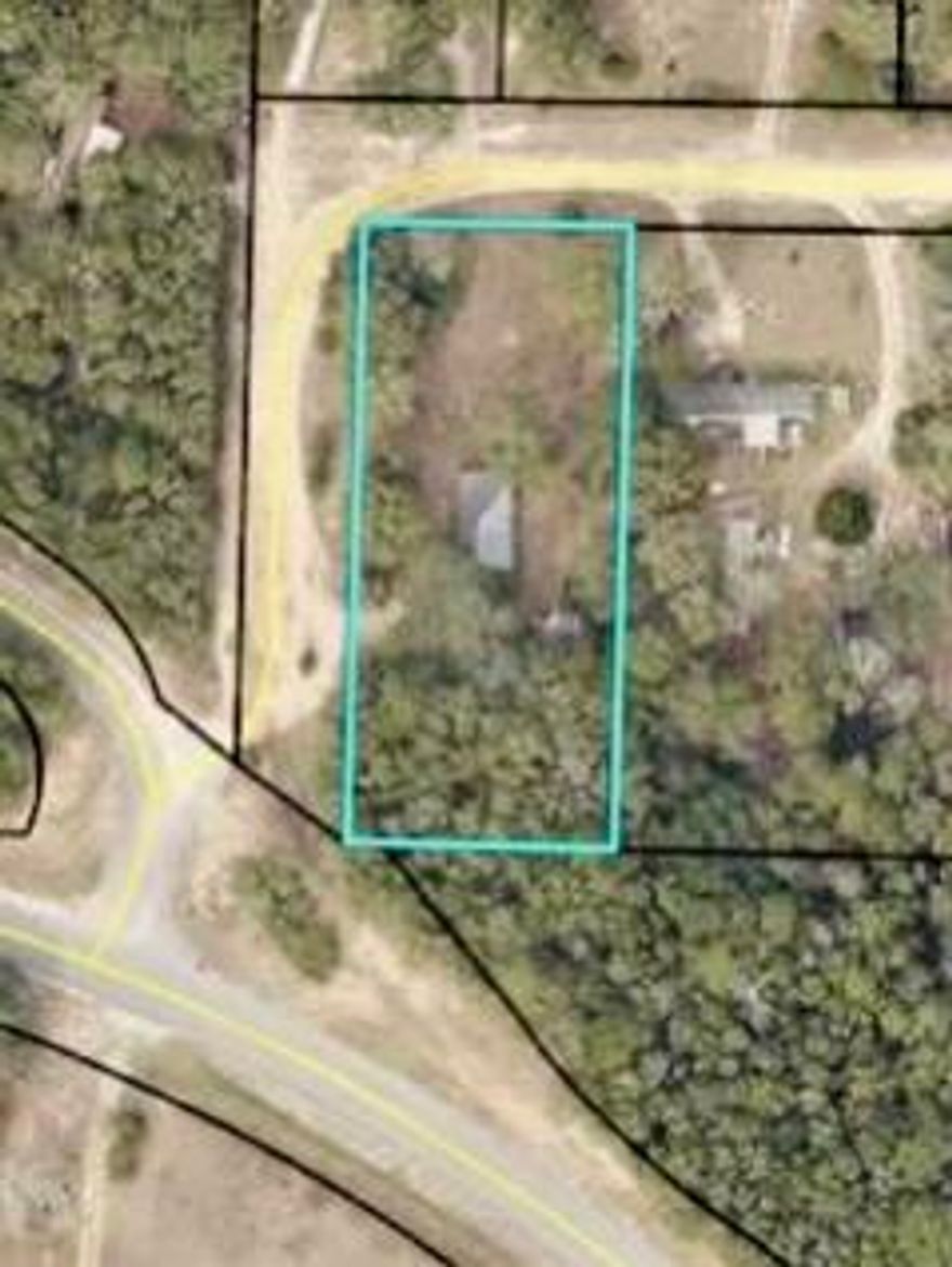 This parcel of land is a perfect building spot for a single family home with close access to highway frontage road.  Partially cleared and level lot with some wooded areas.  The mobile home on the property is dilapidated with no value.