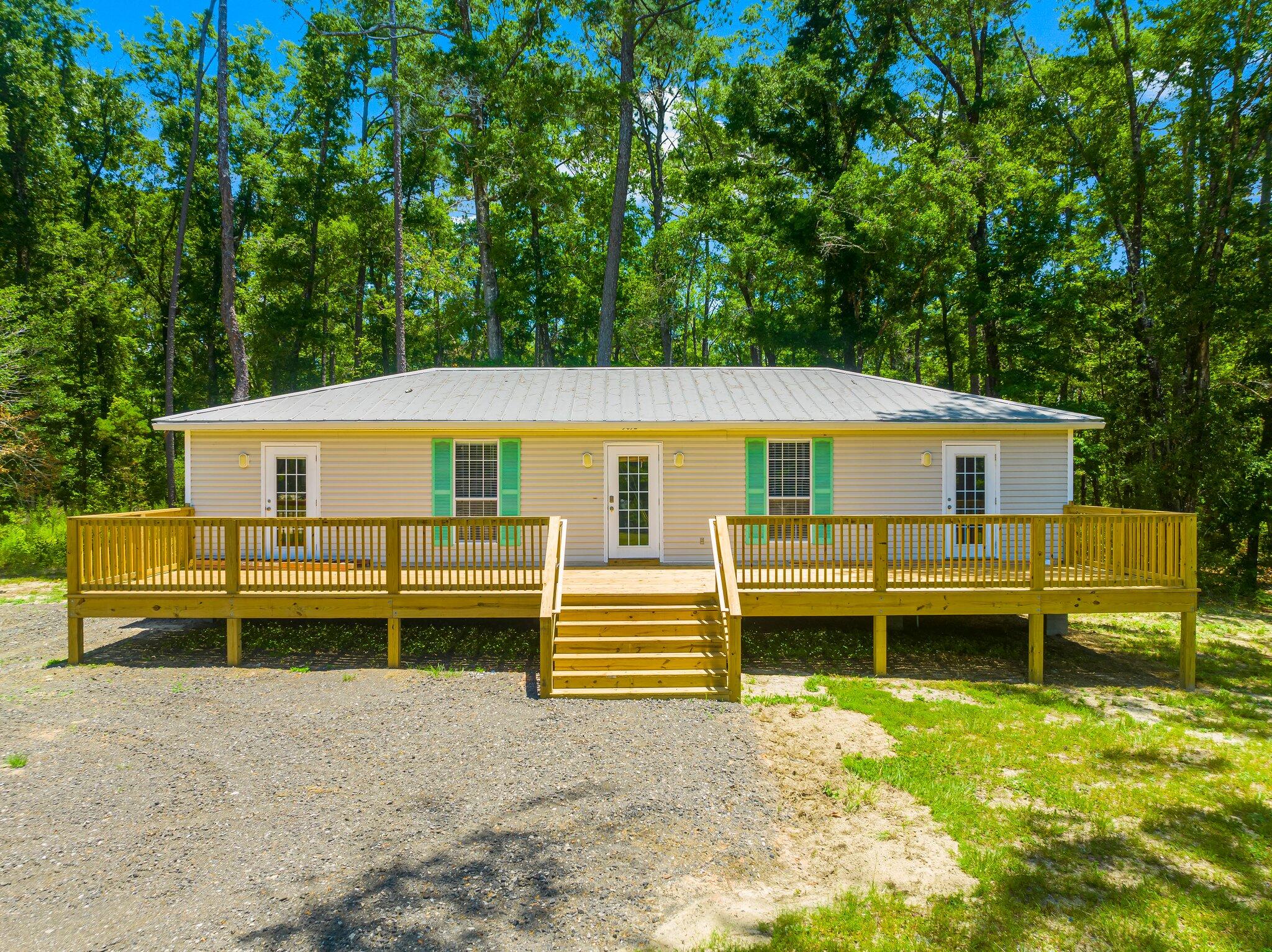 Located on 3 acres with 425 feet of road frontage and 300 ft. on deep water (Black Creek) with plenty of room for multiple vehicles, equipment and storage.This updated 4-bedroom 2 bath, 1650 sq. ft. updated home can be used for living space or multiple office or meeting space.There are non-heated and cooled storage units on the property. If you need more there is plenty of space to add more.