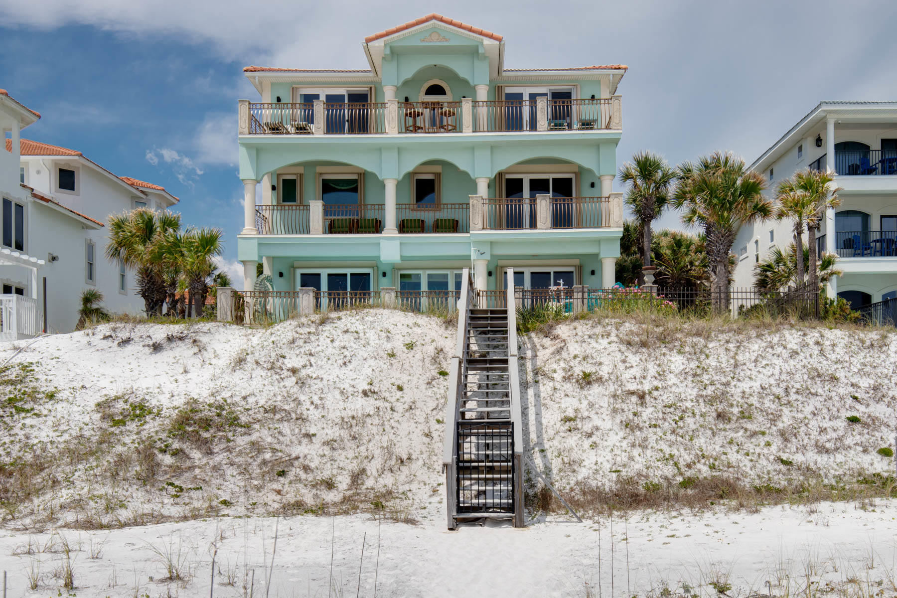 Just Reduced 150k. Casa De Palmas is one of the most exquisite custom beach front homes in Destin. Ideally located in Crystal Beach, and set on 67' of beachfront, this could very well be your families perfect beach house! You first enter a courtyard shaded by palm trees, and are immediately greeted by an impressive grand entrance staircase with cast stone columns and balustrades. The custom Walnut door is surrounded by a beautiful stained glass window installation that was made for this home. As you enter you're met by ocean views, but as you look closer you'll notice the comfortable and inviting floor plan, with MANY recent upgrades. There are Pecky Cypress ceilings in the main living areas and bedrooms, and a mixture of hardwood and stone floors.