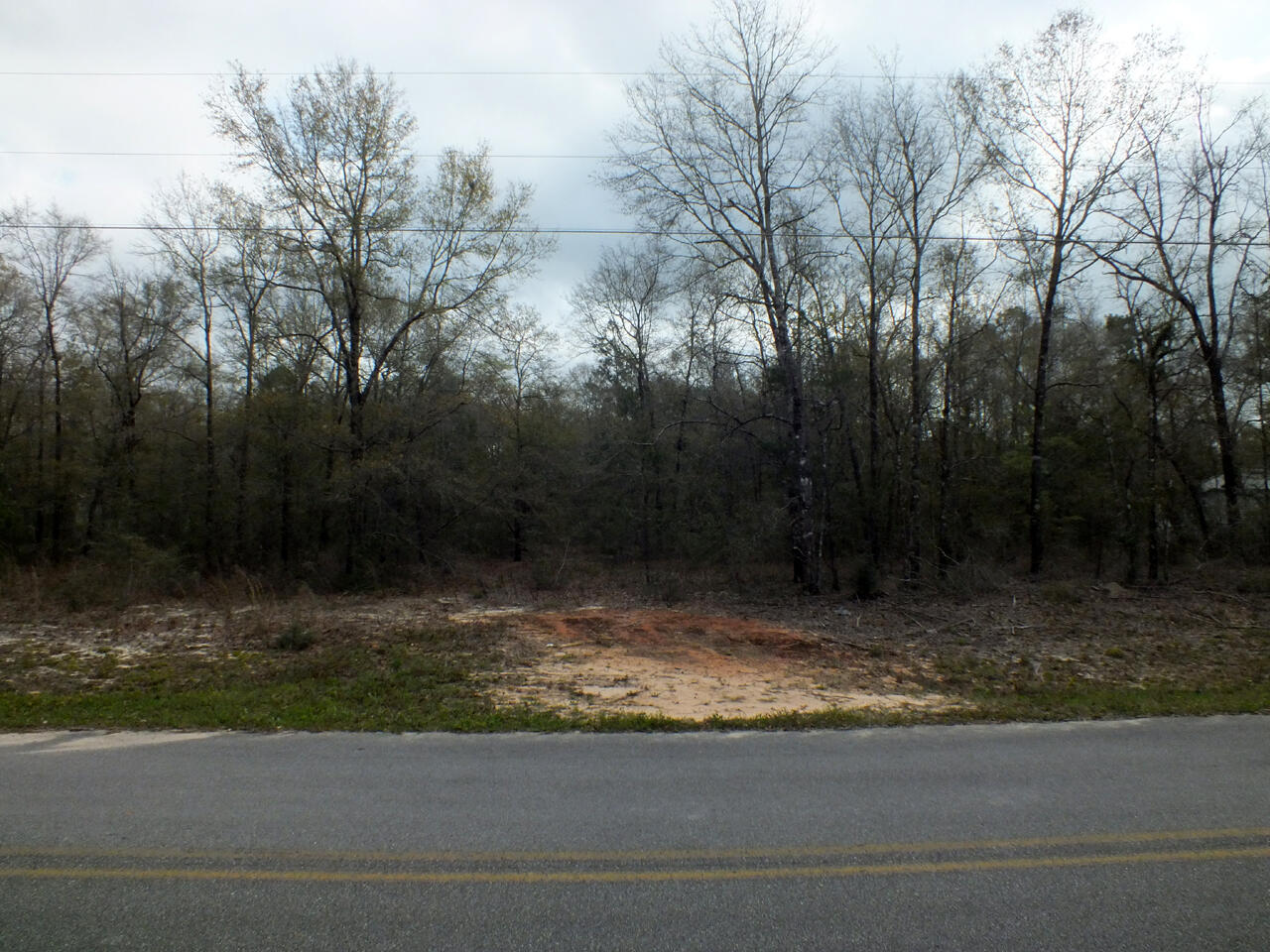 Nice buildable 1.4 acre lot in a small one road subdivision, comprised of well maintained manufactured homes. A copy of the subdivision plat map can be viewed in Documents. The water tap fee has been paid; however, a septic system will be required. The subdivision is located just 4 miles west of historic downtown DeFuniak Springs, voted the best small town in Florida by Mainstreet USA, and within an hour of the shopping, dining and beaches of South Walton.