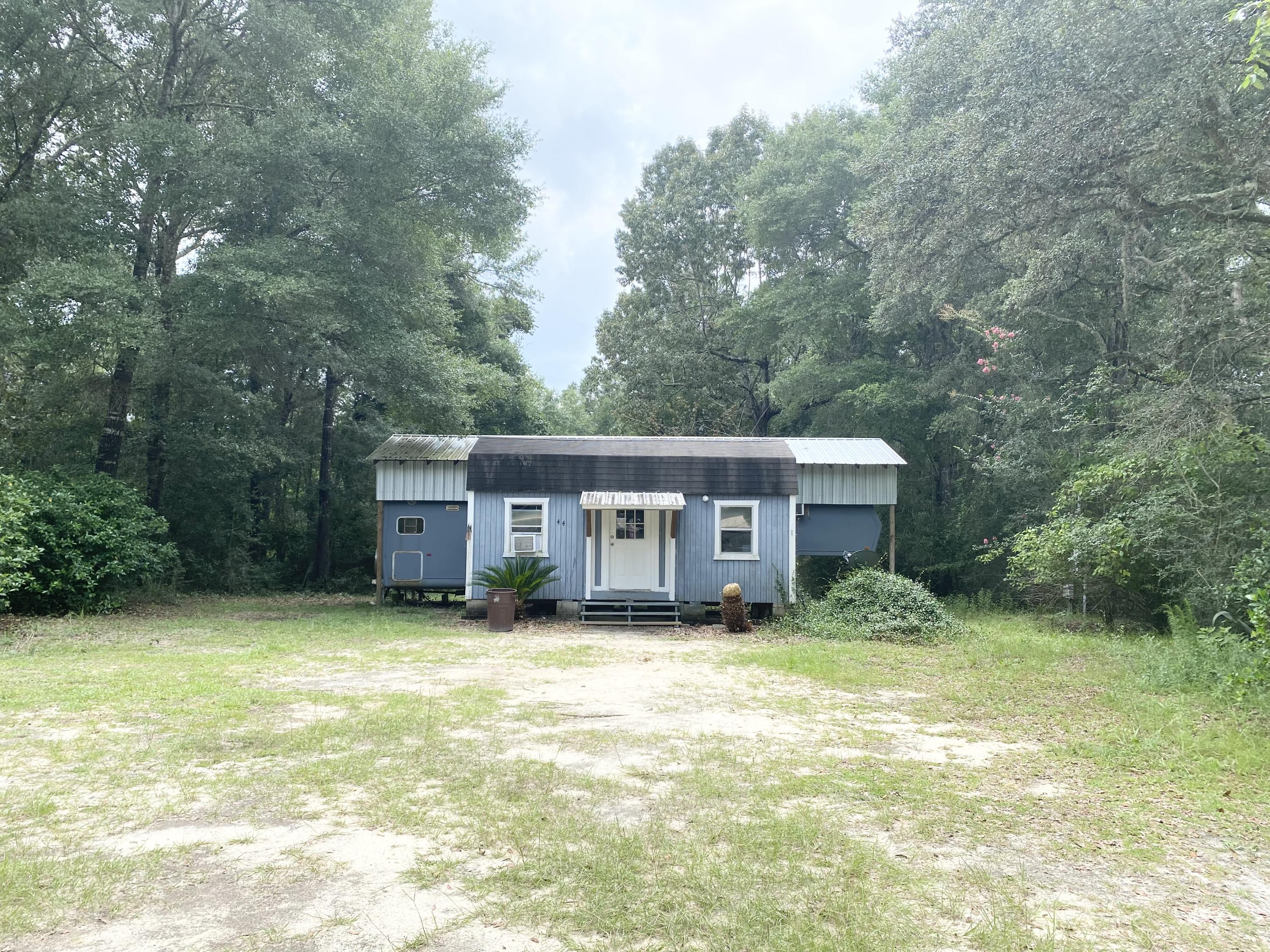 This property has so may options!! Investor looking for a rental property? Getaway spot close to the lake? Vacant land to put your new home that already has all of the improvements? This .32 acre lot has a pole barn (11.5 x 38) set up for RV parking, storage building (20 x 16), electric, public water, & septic. There is also an RV on the property that needs a little TLC. It's less that 1/2 mile to King Lake for all of your fishing needs. King Lake is approximately 580 acres and well stocked with black bass, crappie, shell-cracker, and bream. Located 6 miles from the city of Defuniak Springs & less than an hour from the beautiful white sands of the Gulf of Mexico. Give us a call to view this property in person!