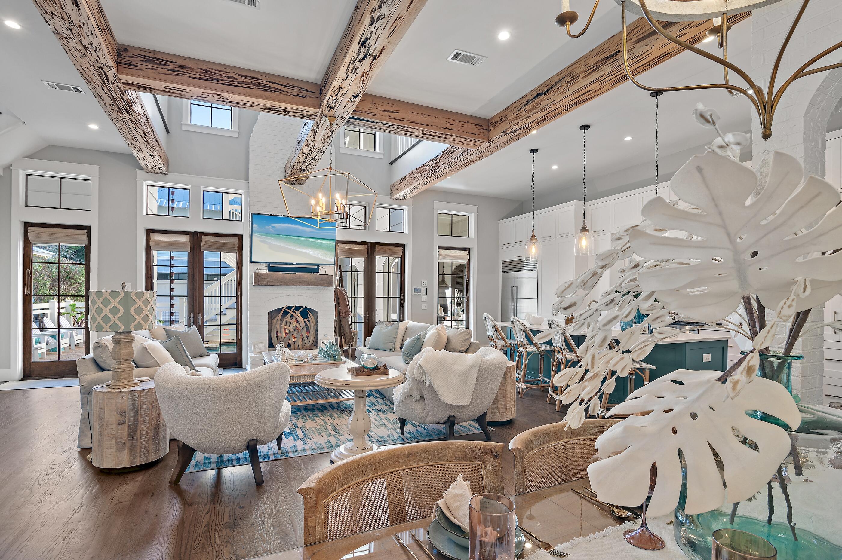 Prepare to be wowed by this exceptional 6 bedroom (+2 bunk rooms) 6.5 bath luxury vacation home, complete with a home theater, and an exercise room, located in the highly sought after Phase 3 of WaterColor. Just steps away from the scenic walking paths and access points to the stunning Coastal Dune Lake, this property offers the ultimate in relaxation and recreation. Step into your private oasis featuring a backyard retreat with a sparkling pool and outdoor fireplace, seamlessly connected to a grilling porch equipped with an ice maker, fridge and pool shower - perfect for entertaining. The elegance of this home is showcased across three levels, adorned with exquisite finishes such as Venetian plaster, painted brick, Pecky cypress, and designer lighting. The kitchen, remodeled in 2020, boasts custom cabinets, a stunning Dianna White Polished Marble and Pearl Mosaic Tile backsplash, quartz countertops, and a 48" SubZero refrigerator, making it a chef's delight. The open-concept kitchen, living room and dining area are highlighted by a one-of-a-kind commissioned painting by Justin Gaffery, adding a unique touch to the space. 

With both first and second-floor master suites featuring ample closet space and private access to outdoor porches, comfort and privacy are paramount. Designed by renowned architect Blu Line Studio, no detail has been overlooked in this three-story masterpiece. 

The impressive living room features a centrally located fireplace, complemented by an outdoor fireplace just steps from the pool, creating a perfect ambiance for cozy gatherings. Relax by the soothing sounds of the waterfall that flows into the heated pool or enjoy the convenience of a dedicated study/office on the first floor, along with three laundry areas throughout the home. 

The property includes a two-car garage equipped with a brand new 6-person golf cart for easy transport around the resort community. The residence features multiple outdoor porches and balconies, providing perfect retreats for some peaceful downtime away from the family. The carriage house can be accessed via ground floor stairs or through the main house on the second story, offering additional flexibility. 

With a recently installed state-of-the-art security system, including thermostats and cameras easily accessible via phone or iPad, this meticulously maintained property is not only an exceptional rental investment but also a beautiful vacation home that is sure to impress. Don't miss your chance to experience luxury living in the heart of WaterColor.  