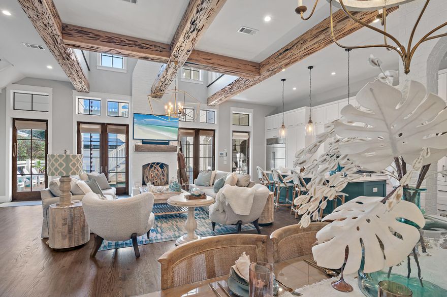 Prepare to be wowed by this exceptional 6 bedroom (+2 bunk rooms) 6.5 bath luxury vacation home, complete with a home theater, and an exercise room, located in the highly sought after Phase 3 of WaterColor. Just steps away from the scenic walking paths and access points to the stunning Coastal Dune Lake, this property offers the ultimate in relaxation and recreation. Step into your private oasis featuring a backyard retreat with a sparkling pool and outdoor fireplace, seamlessly connected to a grilling porch equipped with an ice maker, fridge and pool shower - perfect for entertaining. The elegance of this home is showcased across three levels, adorned with exquisite finishes such as Venetian plaster, painted brick, Pecky cypress, and designer lighting. The kitchen, remodeled in 2020, boasts custom cabinets, a stunning Dianna White Polished Marble and Pearl Mosaic Tile backsplash, quartz countertops, and a 48" SubZero refrigerator, making it a chef's delight. The open-concept kitchen, living room and dining area are highlighted by a one-of-a-kind commissioned painting by Justin Gaffery, adding a unique touch to the space. 

With both first and second-floor master suites featuring ample closet space and private access to outdoor porches, comfort and privacy are paramount. Designed by renowned architect Blu Line Studio, no detail has been overlooked in this three-story masterpiece. 

The impressive living room features a centrally located fireplace, complemented by an outdoor fireplace just steps from the pool, creating a perfect ambiance for cozy gatherings. Relax by the soothing sounds of the waterfall that flows into the heated pool or enjoy the convenience of a dedicated study/office on the first floor, along with three laundry areas throughout the home. 

The property includes a two-car garage equipped with a brand new 6-person golf cart for easy transport around the resort community. The residence features multiple outdoor porches and balconies, providing perfect retreats for some peaceful downtime away from the family. The carriage house can be accessed via ground floor stairs or through the main house on the second story, offering additional flexibility. 

With a recently installed state-of-the-art security system, including thermostats and cameras easily accessible via phone or iPad, this meticulously maintained property is not only an exceptional rental investment but also a beautiful vacation home that is sure to impress. Don't miss your chance to experience luxury living in the heart of WaterColor.  