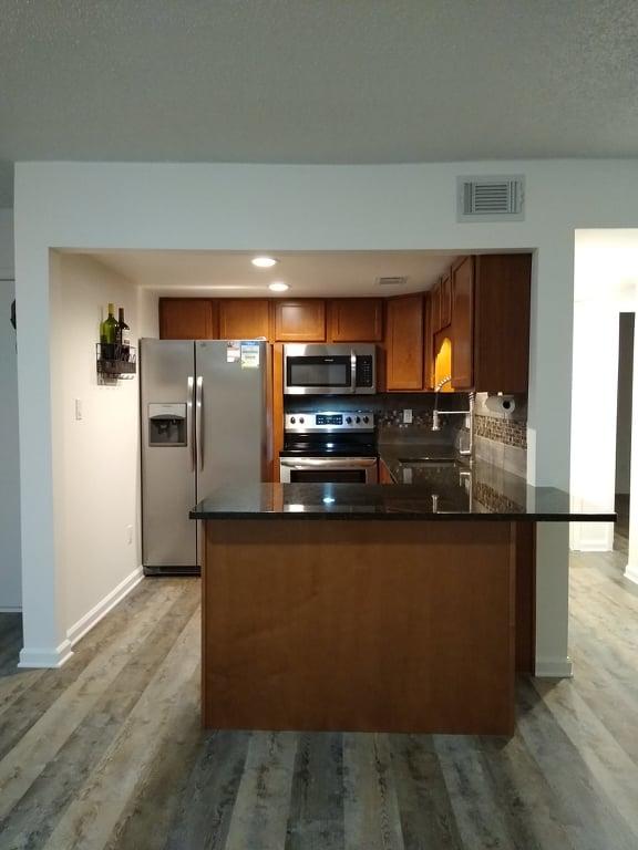 Enjoy a low-maintenance lifestyle in a quiet location. This desirable first-floor two bedroom, one bath Unit has been completely renovated! This condo offers a lovely open kitchen with sleek cabinetry, granite countertops and stainless steel appliances. The main living area is open to the kitchen, light and bright, with new ceiling fans throughout. Enjoy a new bathroom with a walk in shower and quality finishes, fixtures and fittings. There are beautiful LVP floors throughout this Unit, and no carpet! This Unit includes a washer/dryer combo, tankless water heater, and a new HVAC unit. The south-facing position of this property ensures maximum light, warmth from the sun, with a lovely courtyard view. Fountainhead residents enjoy exclusive access to a sound-side swimming pool, fishing dock, tennis courts and beautiful grounds. Boat slips and storage is on a first come/serve basis. This condominium is hard to beat, and is offered at an affordable price.