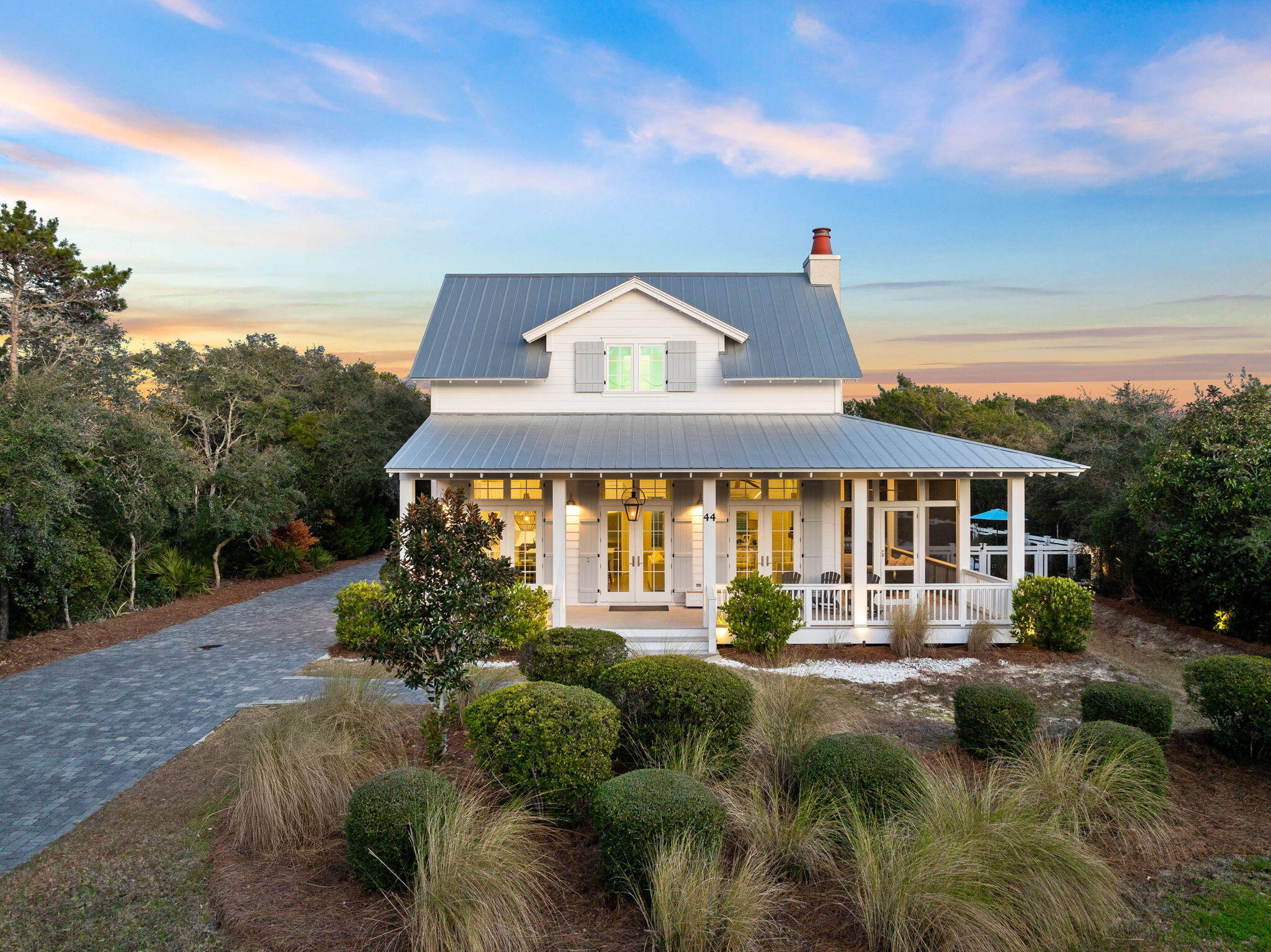 Nestled in the eastern end of 30A, 44 Seacrest Drive captures the essence of coastal living. Enjoying a sought-after location by the beach, this residence offers both convenience and tranquility. Step inside to discover a meticulously curated interior that seamlessly blends modern elegance with seaside charm. The dream kitchen showcases inset cabinetry along with Wolf & Sub-Zero appliances. Boasting beautiful quartz countertops, the large island is the perfect gathering space in the kitchen. The living room has been exquisitely designed with a gorgeous fireplace & opulent furnishings. The screened-in porch features comfortables spaces for outdoor dining & lounging. Overlooking the pool, the outdoor kitchen has been fully equipped with a gas grill, refrigerator & sink. The backyard is an absolute oasis with its 34x16 heated private pool, bubbling spa & artificial turf yard. The charming home features six bedrooms, each offering a tranquil retreat at the end of the day. The main house offers living spaces on the first and second levels. The carriage house has been superbly designed with a full kitchen, roomy living/dining areas & long porch overlooking the pool. As an added bonus, the property has a 2 car garage along with a 140ft driveway. The property has generated strong rental income yearly and comes with a rental projection of $286,895 for 2025. The property can easily accommodate up to 14 total guests. 44 Seacrest Drive has been diligently crafted to provide an unparalleled 30A experience. Inquire today to set up a private showing.