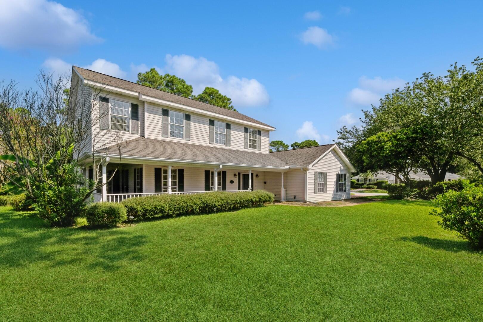 Assumable VA loan with 2.25% interest rate! What a great LOCATION -beautiful large corner lot in the highly sought-after gated community of Southwind in Bluewater Bay! This spectacular home has tons of curb appeal starting with a side-entry garage, paver driveway, walkways, & rear patio. You'll adore the southern style covered wrap around front porch surrounded by mature landscaping. Upon entering the front door, you can't help but notice the stunning hardwood floors, crown molding & a traditional wood staircase.