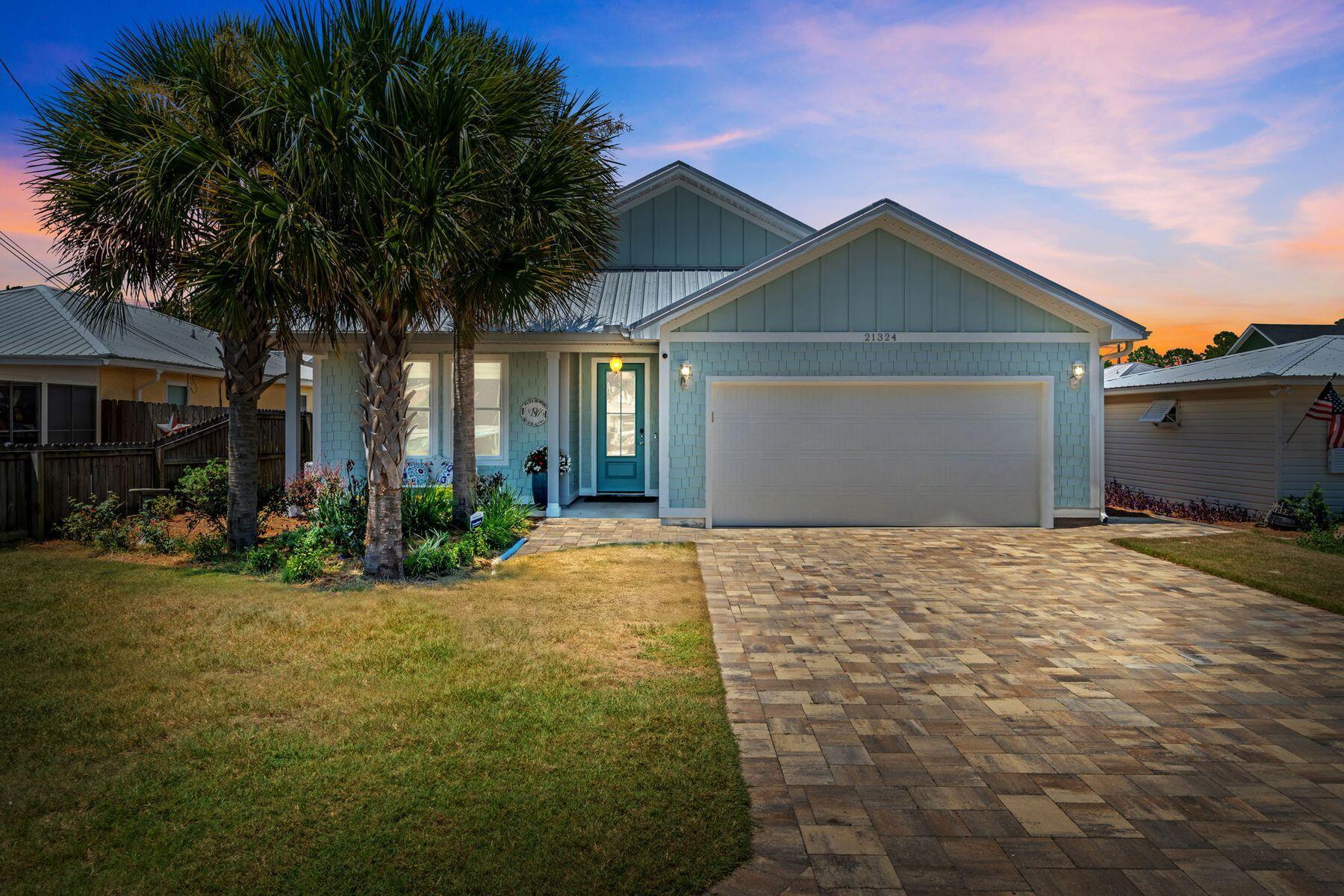 Located in the desirable Riviera Beach neighborhood on the west end of Panama City Beach, this thoughtfully designed 3-bedroom, 2.5-bath home offers the ideal blend of style, comfort, and convenience--just 2 blocks from the beach. Built in 2022, the home features an open-concept layout filled with natural light, a modern coastal color palette, and quality finishes throughout. The kitchen is well-appointed with ample storage and seamlessly connects to the main living and dining areas, making entertaining effortless. Enjoy your own private backyard retreat with a saltwater pool, paver patio, and tropical landscaping--perfect for relaxing or hosting friends and family. No HOA and can be short term rented