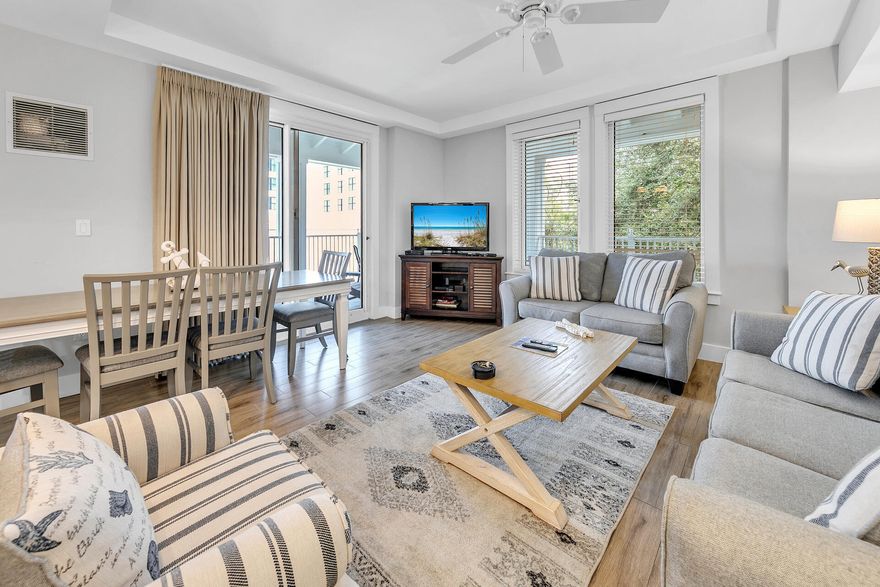 Major Price Adjustment -Nestled in the heart of The Village of Baytowne Wharf, this fully furnished 2-bedroom lock-off condo offers exceptional rental flexibility, allowing it to be rented as either entirely a 2- bedroom , a 1-bedroom unit or a studio. The expansive wrap-around balcony is ideal for both relaxing and entertaining guests. Inside, you'll find elegant, durable luxury vinyl flooring, sleek granite countertops, and an of large windows that flood the space with natural light. Side one features everything you need to comfortably sleep 4 complete with a sleeper sofa.  Spacious main bedroom offers a king-size bed.  Want to have additional guests?  The adjoining studio is equipped with 2 queen beds, a kitchenette, and a full bath. Extra storage is available with a dedicated storage cage, perfect for keeping beach toys and gear. Residents and guests enjoy exclusive access to a resort-style pool, hot tub, grilling area, and fitness center. Sandestin Golf and Beach Resort boasts over seven miles of beautiful beaches and pristine bayfront property. The resort includes four championship golf courses, 15 world-class tennis courts, a 226-slip marina, a fitness center, a spa, and dining experiences from celebrity chefs. Guests can shop, dine, and enjoy various activities in The Village of Baytowne Wharf, a charming pedestrian village within the resort. Residents experience a luxurious lifestyle across 2,400 acres stretching from the beach to the bay. The entire resort is accessible by golf cart or bicycle, with miles of interconnected paths that wind through groves of live oaks, natural lagoons, fountains, man-made lakes, and beautifully landscaped fairways.