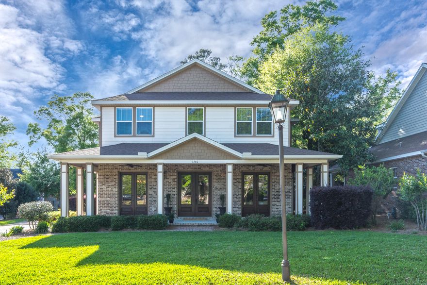 Find this truly elegant New Orleans style home tucked away amongst mature oaks, steps from the protected waters of Ward Cove, in Niceville's quaintest hamlet - The Parish at Bluewater Pointe. Brimming with charm and a family-friendly atmosphere, this single street, 16-home neighborhood offers community water access via shared pier, brick paver street and driveways, and central gathering area with picnic table. A distinctly Southern wrap around porch with classic wood ceiling draws you in from the street and through glass paneled double doors to the wide foyer. The high quality finishes and refined color palette immediately impress - 10 foot ceilings, acacia hardwood flooring, crown moulding and millwork, 8 foot solid wood doors, and custom light fixtures. The main floor offers the perfect