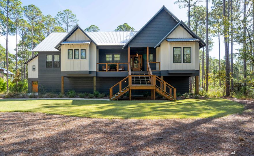 This stunning 4-bedroom, 4-bathroom home blends craftsman charm with modern luxury, featuring a spacious 3700 sq. ft. open floor plan and elegant custom finishes throughout. Beautiful hardwood floors and oversized windows fill the space with natural light. The inviting entryway leads to a luminous open-concept living, dining, and kitchen area. The chef's kitchen boasts quartz countertops, custom cabinetry, and high end appliances. Enjoy the privacy of a split floor plan, with a serene master suite that includes a large walk-in closet. The master bathroom features marble throughout and showcases a soaking tub and a walk-in shower for a spa-like experience. The outdoor area features an impressive salt water pool, a hot tub, an outdoor kitchen and a Pynamite Mosquito Misting System that The outdoor area features an impressive salt water pool, a hot tub, and an outdoor bar area that creates the perfect space for relaxation and entertaining. Downstairs, you'll find an expansive bonus room designed for endless enjoyment. With plenty of space for games, entertainment, and gatherings, this area is perfect for hosting friends or creating a cozy retreat for family fun. The one-bedroom carriage house, complete with a full bathroom, offers the perfect private retreat for guests, adding both comfort and versatility to the property. Residents here can enjoy boating, paddle boarding, fishing, and scenic hikes along the community's extensive trails. With a convenient on-site boat ramp and a place to park/leave your boat, accessing the Gulf of Mexico is effortless, making it ideal for water enthusiasts. Experience the magic of coastal living where luxury and nature meet, and enjoy the unique opportunity to feed the deer right in your own backyard! This exceptional home is a rare gem, offering privacy, generous space, and access to an amazing community!