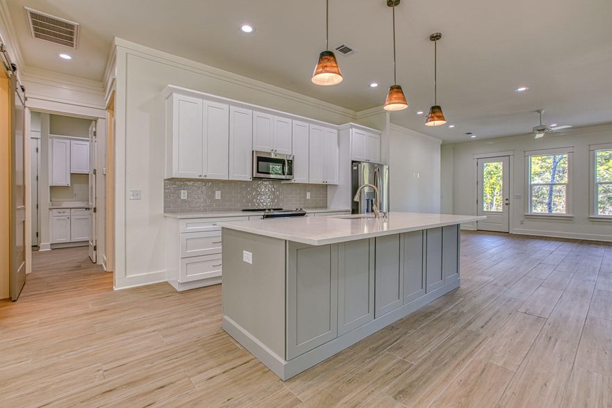 New construction! Highly desirable one story open floor plan with an attached oversized 2 car garage. This 3 bedroom and 3.5 baths custom home offers finishes unlike any other properties in this price range. Home offers an open floor plan with plank tile floors, solid wood shaker style cabinets, quartz counter tops, shiplap walls, a walk in pantry, and a mudroom with custom cabinets. The master bath has a double vanity, tiled shower, and leads to a large 13x11 walk in closet. Each additional bedroom has its own full baths and walk in closet.Other features in this home includes impact windows,10ft ceilings, solid 8ft doors, crown molding, foam insulation in attic, fenced back yard, plenty of storage and covered front and back porches. Back porch has a 55in tv