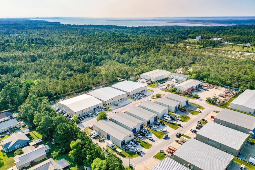 Approximately 5000 square foot warehouse! This property has been cleared out and is ready to sell! Photos are not updated. This property is on a corner lot and is large. The front section was being used as 5 office stations, a conference area, an air conditioned bathroom, refrigerator and water hook ups for sink or washer and dryer, 24 foot ceilings in the main area with a 20 roll up door, a gated cage for valuables, and a 4 foot wide stair case that leads to a double reinforced floor upstairs that can be additional office space / flex area. The rear section has 1000 square feet, with a tenant, Marrow Private Chefs. It has a built in kitchen, another air conditioned bathroom, a second level private office and currently has a lease of $1200.00 per month and $150.00 toward utilities.