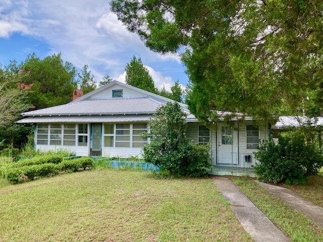 Endless Possibilities for this 1.12 acre parcel located along Hwy 90W, across the Highway from Eagle Springs Golf Course, and just one-mile from downtown DeFuniak Springs. The property consists of an older 2000+ sq. ft. heated & cooled home plus a large cleared and grassy lot. Possible low impact uses in this C-1 zoning designation are: residential, professional office space, restaurant, retail store, day care center, etc. Existing home could be remodeled and put to use, or torn down for new construction.