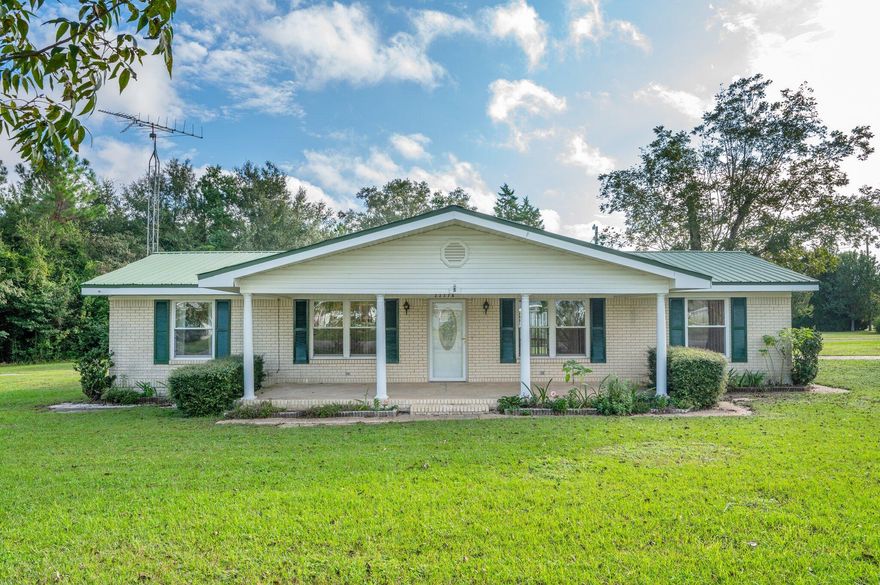 Spacious 3 bedroom, 2 bath brick home located in the Paxton Community in North Walton County. Home features large kitchen with breakfast bar, dining area and combo Living Room and Family Room. Oak floors in the dining, living room areas. Family room, kitchen and baths all have ceramic tile with carpet in the bedrooms. Kitchen features stainless appliances plus an upright freezer. Master bedroom has 2 closets. 28.6x10.5 covered front porch. Metal roof.  Easy access to interior with 2 carports. Beautiful landscaping plus pecan trees. Paved driveway and sidewalks around the house. Property also includes a detached garage plus a huge RV garage. All located near the Paxton School (an A K-12 school), Paxton ball park plus Beautiful Lake Jackson for all water sports, walking trails and picnics!