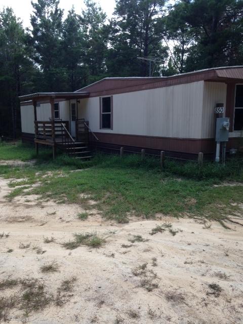 County....County..and slightly secluded on this 2 acres with a fixer-upper 1983 single wide mobile home. Property had new septic and well installation when cleared and home was placed in 2000.If you are good with making improvements, then this is for you..what a bargain...the land and improvements are worth the asking price..must be CASH buyer.