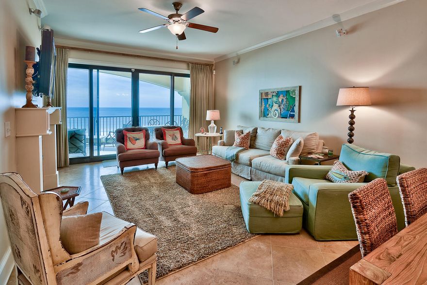 This low-rise condo building, occupying just over 300 feet of private beachfront, is convenient to some of Destin's most popular attractions and is just over one and a half miles from the foot of the Mid-bay Bridge, making it especially accessible for anyone driving into the area. Handsome, diagonally-laid tile floors carry throughout the open principal living areas and baths while plush carpet can be found in each of its four spacious bedrooms. Raised panel kitchen cabinets showcase rich granite counters and a tumbled marble tile back splash, which are joined by modern Viking stainless steel appliances. Anchored by a gas fireplace, the living room area opens onto an expansive covered balcony, with space enough to both lounge and dine.