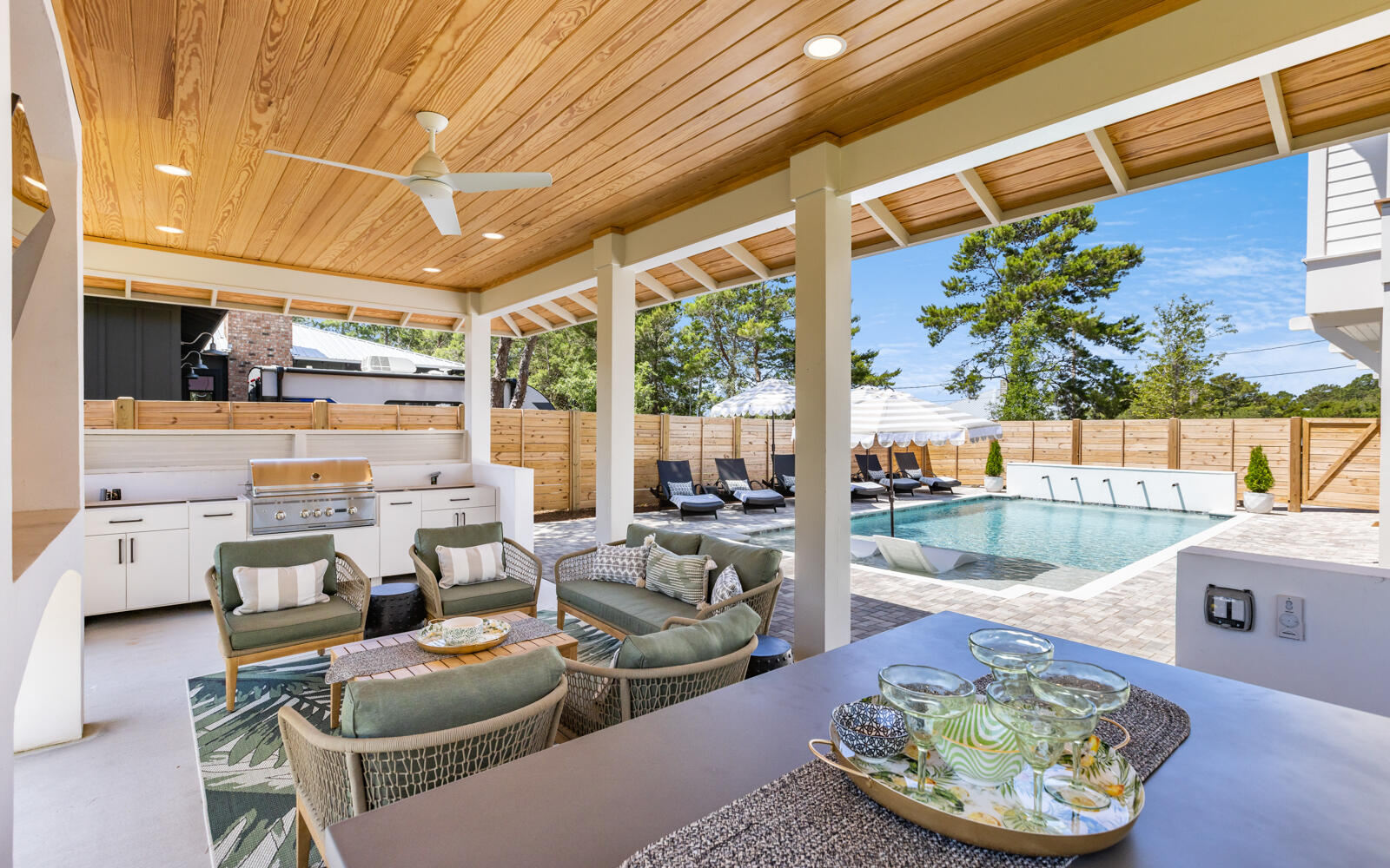 This magnificent home is situated on a quarter-acre lot with breathtaking 40ft elevations and boasts an array of luxurious features. The centerpiece of the property is its private heated pool, surrounded by a cabana for outdoor cooking and dining, creating the perfect setting for al fresco entertaining. The pool area is fenced for privacy and play, making it a safe haven for families. The main living and master bedroom are located on the second floor, with the master bathroom offering a private outdoor shower and a private porch with views of the backyard. The first level includes an additional on-suite bedroom, a guest bath with laundry, and two bedrooms, one of which is fitted with 4 queen size bunk beds. Recently remodeled in 2022 to optimize rental income with many upgrades.