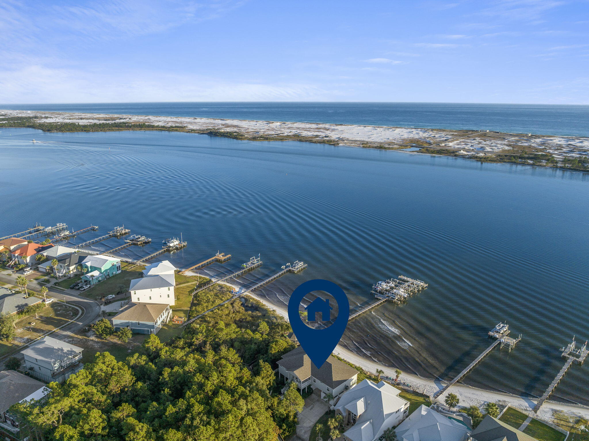 Immerse yourself in luxury and tranquility with this 4-bedroom, 3.5-bathroom custom-built residence, nestled in the coveted Sparkling Waters neighborhood on the Santa Rosa Sound. Included is a deeded boat slip in the marina, complete with a 10,000 pound lift, that you can see right outside your windows. The impeccable curb appeal invites you into a world of panoramic intercoastal views, expansive living spaces, and unmatched style. Inside, 10-ft high ceilings adorned with striking crown molding harmonize with plank tile flooring throughout, all framed by elegant 5 1/4'' baseboards. The gourmet kitchen is a culinary enthusiast's dream, boasting custom ivory-painted cabinetry, sleek granite countertops, top-tier stainless steel appliances, including an oversized commercial-grade refrigerator/freezer, and a spacious pantry.
The generously sized waterfront master suite is a haven in itself, featuring dual walk-in closets, a lavish en-suite bathroom with a glass-enclosed walk-in shower, a whirlpool garden tub, and a double vanity. For entertainers, the waterfront living room and dining area seamlessly merge, extending out to a vast covered porch perfect for alfresco moments. This home features waterviews from the Master bedroom, living room, formal dining room, and additional guest bedroom. Practicality complements luxury with features such as a conveniently located laundry room, a meticulously landscaped yard with a privacy fence, a sprinkler system, well, and timer.
The home's waterfront perks are in a league of their own, offering homeowners an island oasis outside. With breathtaking Gulf and Santa Rosa Sound views evident from the balcony and various rooms, the property stands as a testament to superior waterfront living. Residents will also be delighted with the charming private beach, a pristine swimming pool with custom stone decking, and a private stretch of white sugar sand beach. In 2020, the saltwater pool was built with a heater and measures 30x15. The bonus spacious covered outdoor area, stemming from the finished concrete below, adds to its charm and is perfect for another entertainment space for family and friends just overlooking the water.
Built on a classic piling foundation, the home's design exudes contemporary flair. The residence's prime location, a few miles from Destin and just minutes from Navarre Beach, perfectly balances serene beachside living with proximity to lively attractions. In summary, this Sparkling Waters gem is ideal for boating aficionados, entertainers, or those who desire serene moments enveloped by cool sea breezes. Experience unparalleled waterfront elegance. (There is a boat available for purchase in addition to the home, if interested.)