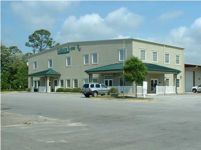 BANK OWNED! Not a short sale! Attractive financing available! Large versatile building sitting on over 300 front feet along Highway 98 offers water views from the second floor. 9,000 sf of office/retail space up front and 5,400 sf of warehouse/shop space attached behind. Six tall roll-up doors. This property contains 2.75 acres and is ideal for an RV or large boat dealership. It would even make a great church or private school - with some modifications.
