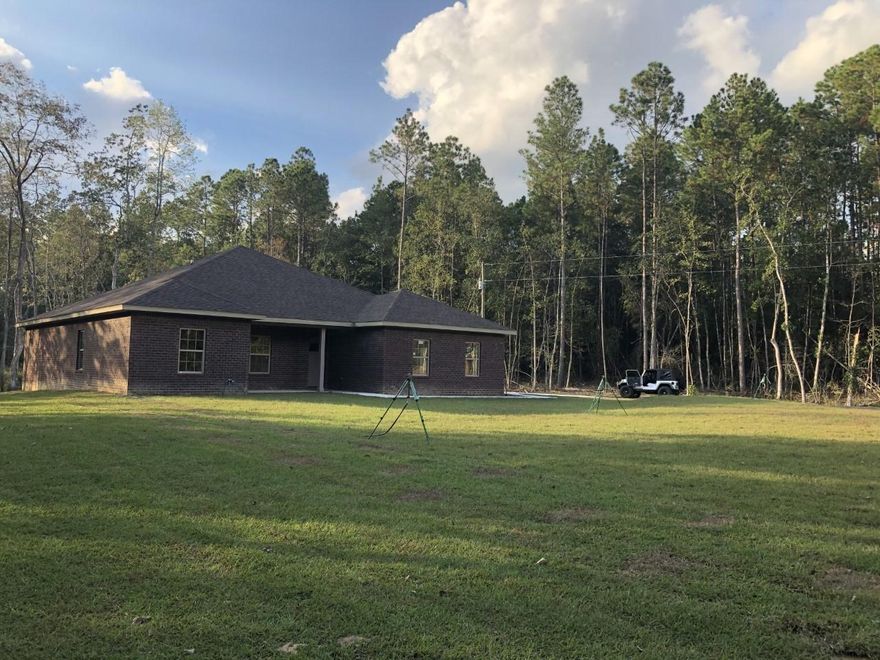 BEAUTIFUL 4 BEDROOM 2 BATH ALL BRICK HOME WITH LANAI SITTING ON 2.38 ACRES.   MANY CUSTOM FEATURES. IN THIS HOME.  9 ft CEILINGS WITH 10 FT IN THE TREY CEILINGS,  A KITCHEN THAT BOAST CUSTOM  WHITE ALL WOOD CABINETS WITH SOFT SHUT DRAWERS, GRANITE COUNTER TOPS ALONG WITH WOOD LOOKING VINYL PLANK IN THE KITCHEN, FAMILY ROOM, BATHROOMS,  BEDROOMS & LAUNDRY ROOM. (THROUGHOUT THE ENTIRE HOME.)  THE FLOOR PLAN IS OPEN MAKING IT PERFECT IT FOR ENTERTAINING!!  THE KITCHEN HAS STAINLESS APPLIANCES AND A LARGE BAR.  THE MASTER BATH IS INVITING WITH ITS  CUSTOM TILE SHOWER  AND GARDEN TUB MAKING IT PERFECT FOR RELAXING AND WINDING DOWN EVENING.  THE  FAMILY ROOM  OPENS UP WITH FRENCH DOORS  TO THE LANAI..  You will see plenty of deer and beautiful sunsets. there's a 17x5 covered front porch and the