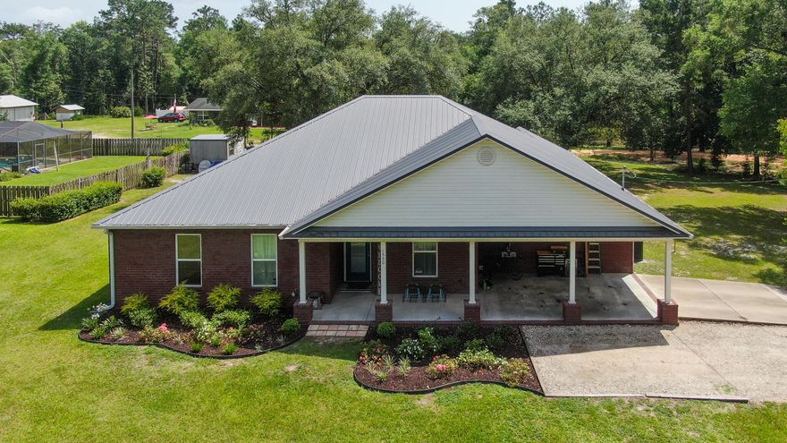 Price Improvement! Expect the unexpected with this nearly new 5 bedroom/ 3 full bath, brick home in the heart of Ponce de Leon, only 30 minutes to the beach and 5 minutes to the clear, ice cold springs for swimming & diving.  The split floor plan is open with large rooms and farm house touches throughout, including real engineered hardwood floors. You'll delight in the kitchen with island, pantry, quartz counters & breakfast area (+ formal dining, currently serving as an office). The master suite has a separate retreat area and bath w/ a huge tile shower, double vanity & walk-in closet. The other 4 beds & 2 full baths give you plenty of space for family or guests. Enjoy the large sitting area off the living room also. The back patio has a large oak for shade and gatherings. Welcome home!