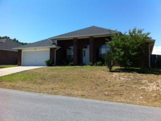 Absolutely gorgeous all brick home in the great community of Lee Farms! This elegantly appointed residence has a split bedroom plan featuring 4 bedrooms and two baths. It is actually a double split with the master bedroom being on one side of the home and the other three on the opposite side but one of those extra bedrooms is located on the opposite side of the great room from the other two. It makes a great study or guest room. The home has a formal living room and a formal dining room separated by a large foyer, plus a gigantic greatroom with vaulted ceiling, plant shelves, and fireplace. Beautiful Berkshire cherry Pergo flooring and ceramic tile floors (carpeting in bedrooms). Gallo Napoleon granite countertops in kitchen with a black granite sink.