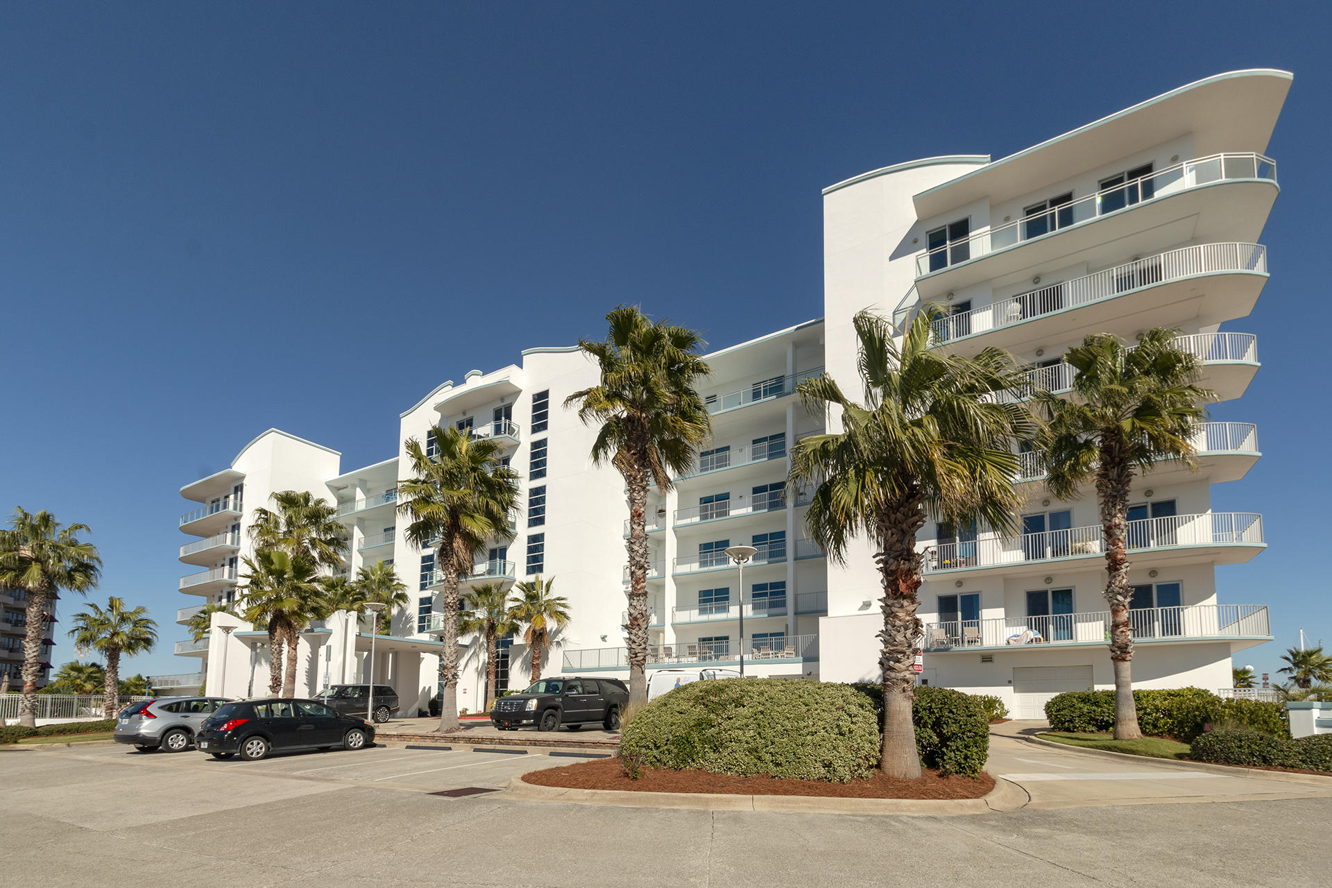 Spectacular views from every room in this 3BR/3.5BA, 3,255SF Penthouse w/ a bunkroom. This penthouse features 1,191SF wrap around balcony with amazing views of the Gulf, Pass, Harbor, & Bay. Other features include 12FT ceiling's, oversized custom doors, & enhanced windows for perfect views. Entering the condo, you are greeted with a $75,000 smart home system, porcelain tile floors, granite countertops, custom wood cabinets & oversized crown molding. This condo also features two master suites, 2 private garages, a 50x22 boat slip, and the largest storage unit in the complex. Harbor Lights features gate access, pool, hot tub, gym, dog park, harbor, & deeded beach access. This is the perfect penthouse even though the building was built in 2007, this condo was a shell until 2014. Call me!!