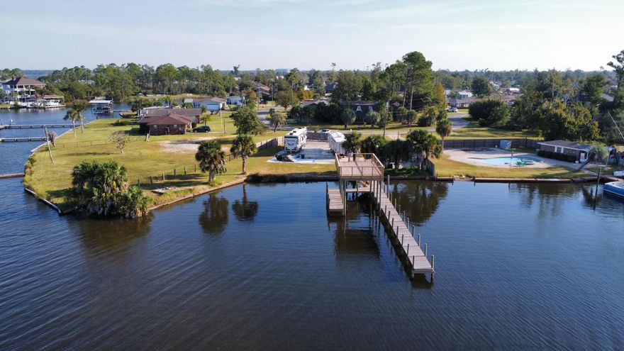 Build your dream home on this half acre Waterfront lot in beautiful Point Havenwood subdivision on Lynn Haven Bayou, with deep water access to the Bay and ultimately the Gulf of Mexico.  This lot features 180 water-front feet and includes in-ground pool and brand new dock with pier a stones throw away from Marina Island. Fireworks during the holidays are amazing to see from this amazing property. A.L Kinsaul Park is within walking/Kayaking distance for all of your major holiday celebrations. Sheffield park is also a short walk/golf kart ride away for your farmers market and concerts. RVs on lot are also available for purchase separately.