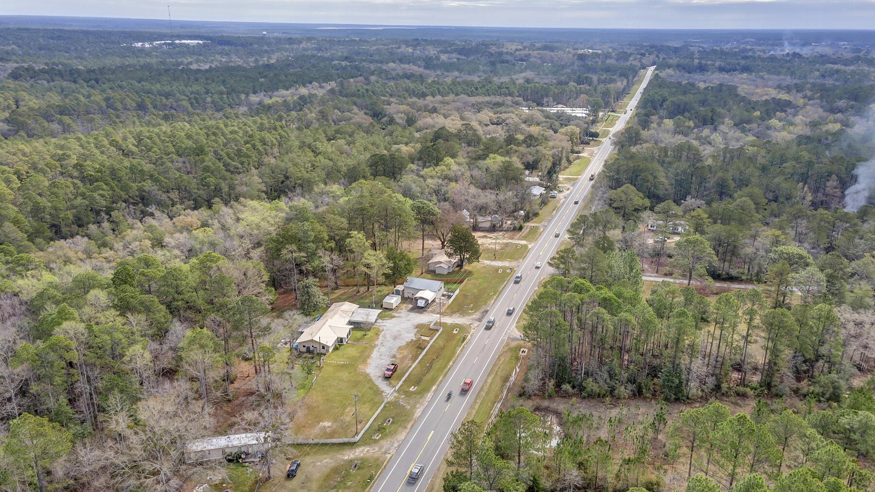 Welcome to Freeport! This 2.38+/- acres is located one mile from town center and 1/4 mile from Hammock Bay! Property is zoned Residential Commercial. The 5/4 home is grandfathered in and can be used immediately without any changes to building footprint (as an office). There is a 40x30 shop/warehouse building that is plumbed for a bathroom. Numerous storage sheds and a large electric changeable sign that is also grandfathered in. Allowable uses include, but are not limited to; office, restaurants, retail stores, motels, shopping centers, parking lots and much, much more! Live in one side, work out of the other! You can do both here! Buy today, open up your business tomorrow! No waiting! Be sure to check out the virtual tour and drone photos. Call to schedule your appointment to view today!