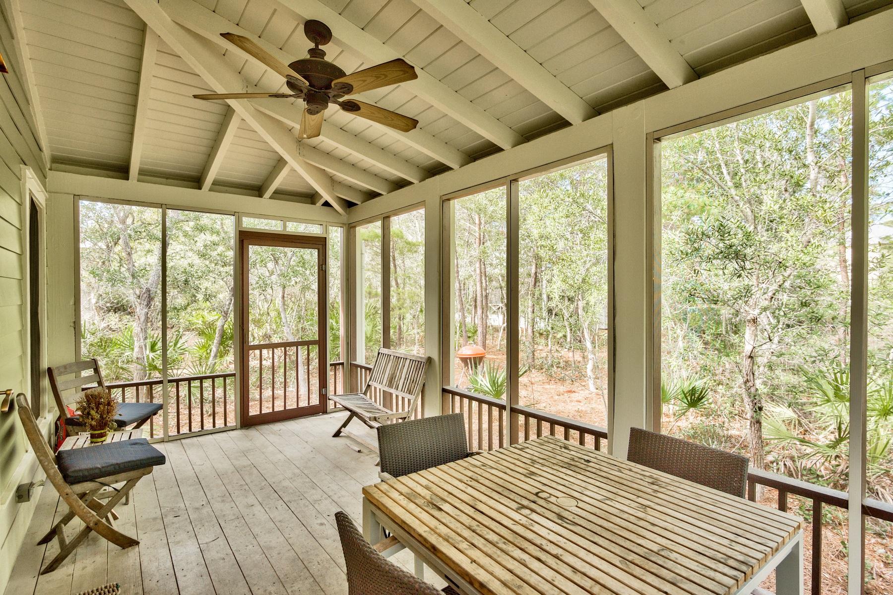 Magnolia Cottages, is southern coastal cottage charm tucked beneath cascading oaks trees for private living that is just a five minute walk from the beach. This 3 bedroom 3 bath home is perfect for a second home or a vacation rental. The neighborhood features a community pool, brick paver streets, a deeded beach access, and golf cart parking along the beach. Located within a very short distance of Alys, Rosemary, and Seacrest Beach, there is easy accessibility to shops and delicious dining. This quaint cottage features beautiful hardwood flooring, an open floor plan with eat-in kitchen, granite counter tops, and a breakfast bar just off the main living area that is perfect for gathering the whole family. The first floor also has 2 bedrooms and 2 full bathrooms, one of which is accessible from the hallway for guests. On the second floor is a spacious master suite complete with walk- in closet, double vanity and a private walk-out deck. There is a large screened in porch on the bottom level that calls you to times of relaxation all throughout the day surrounded by a wooded lot for optimal privacy.