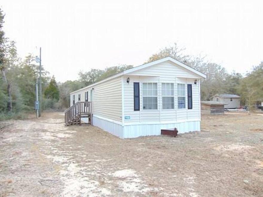Very well taken care of mobile home on over 1 acre! The inside looks like new! This property is located South of I-10 between DeFuniak Springs and Freeport. All measurements must be verified by buyer.